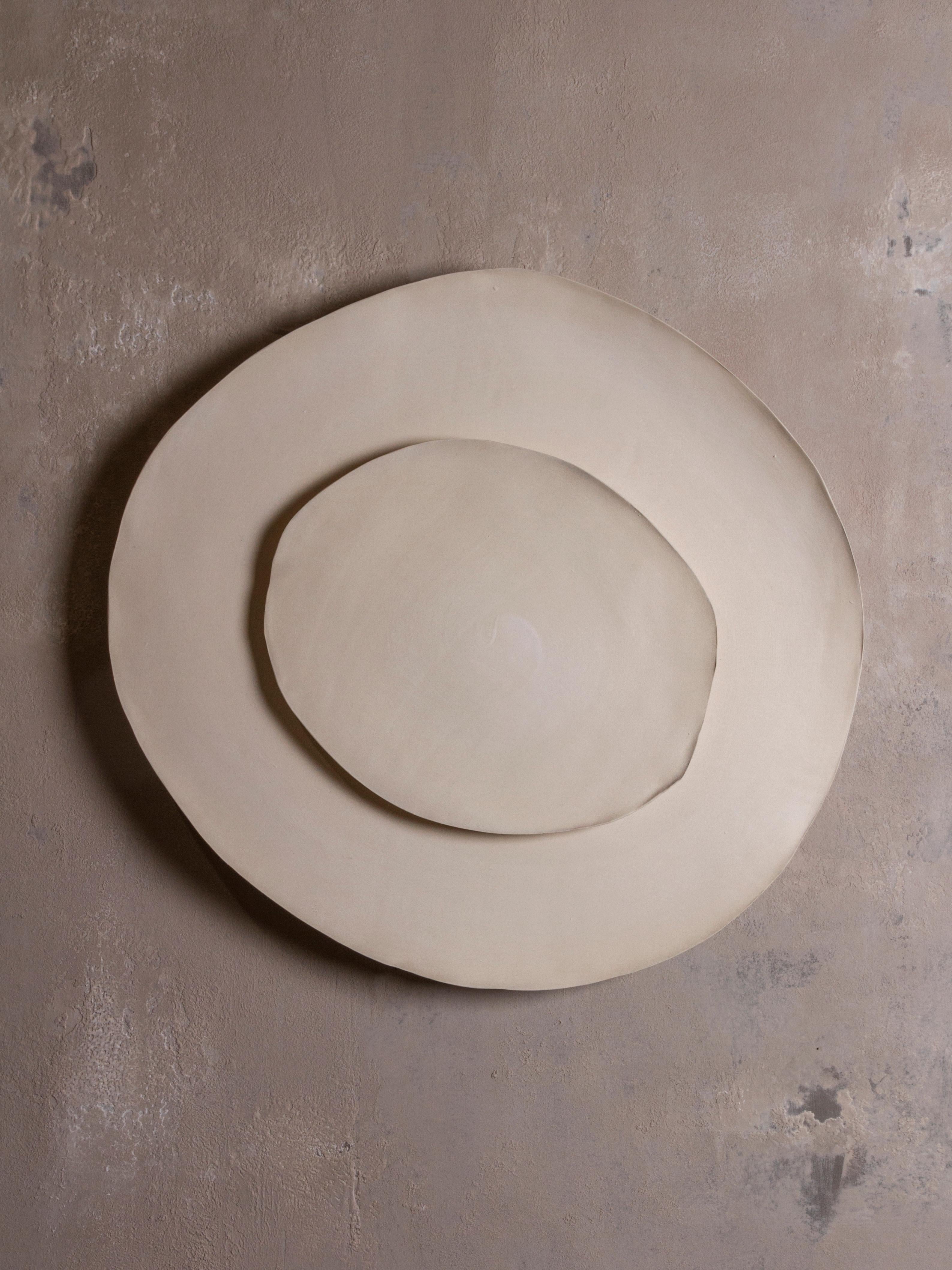 Silk #20 wall light by Margaux Leycuras
One of a Kind, Signed and numbered
Dimensions: Ø54 x H 57 cm
Material: Ceramic, sandy stoneware platters with a porcelain slip finish.
The piece is signed, numbered and delivered with a certificate of