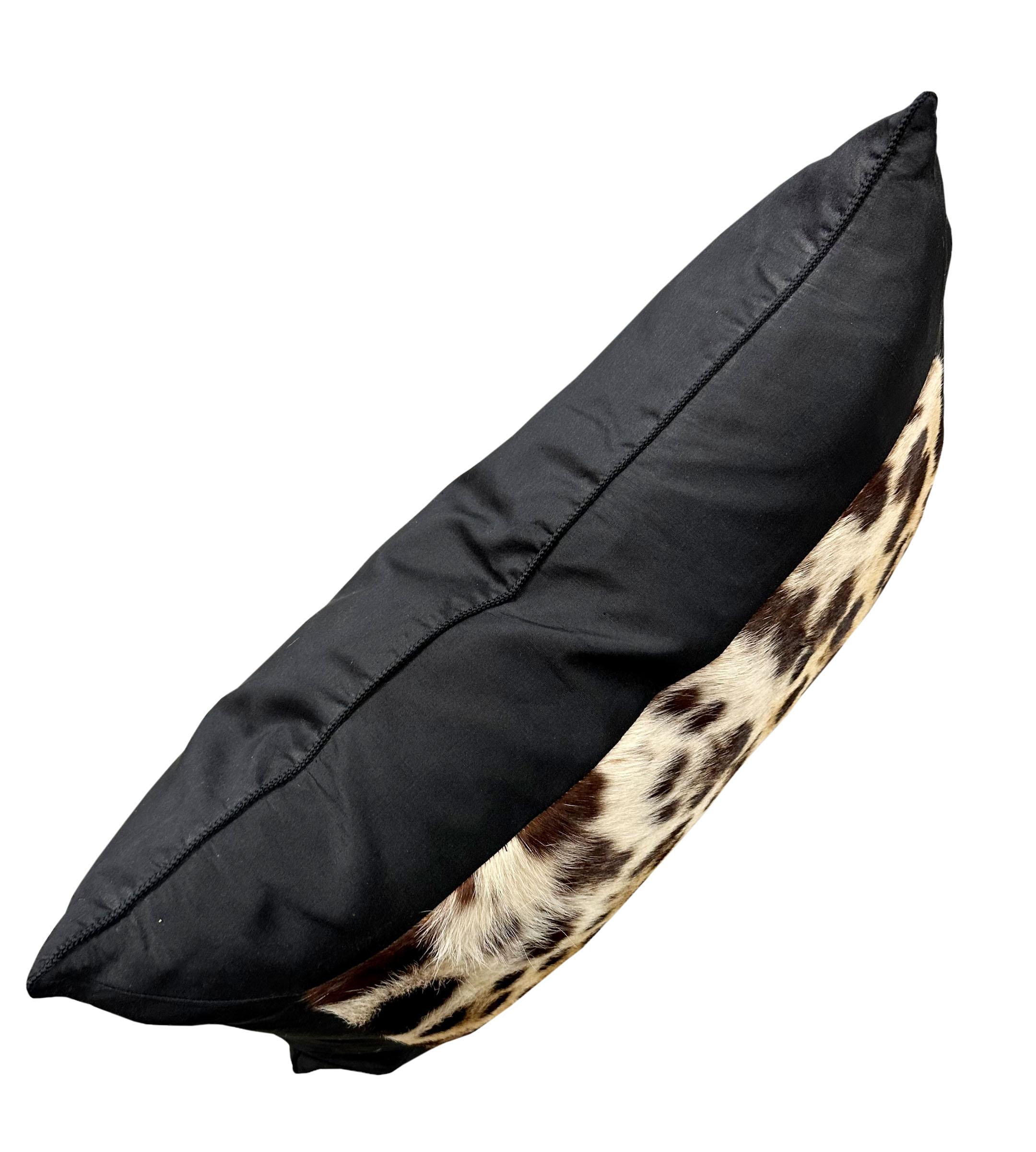 A single handmade, black silk taffeta with genuine leopard skin lumbar pillow. The silk has a micro bladed trim and pillows are filled with goose down and feathers. Pillows are mitered as well to the corners of the leopard. The leopard is 6