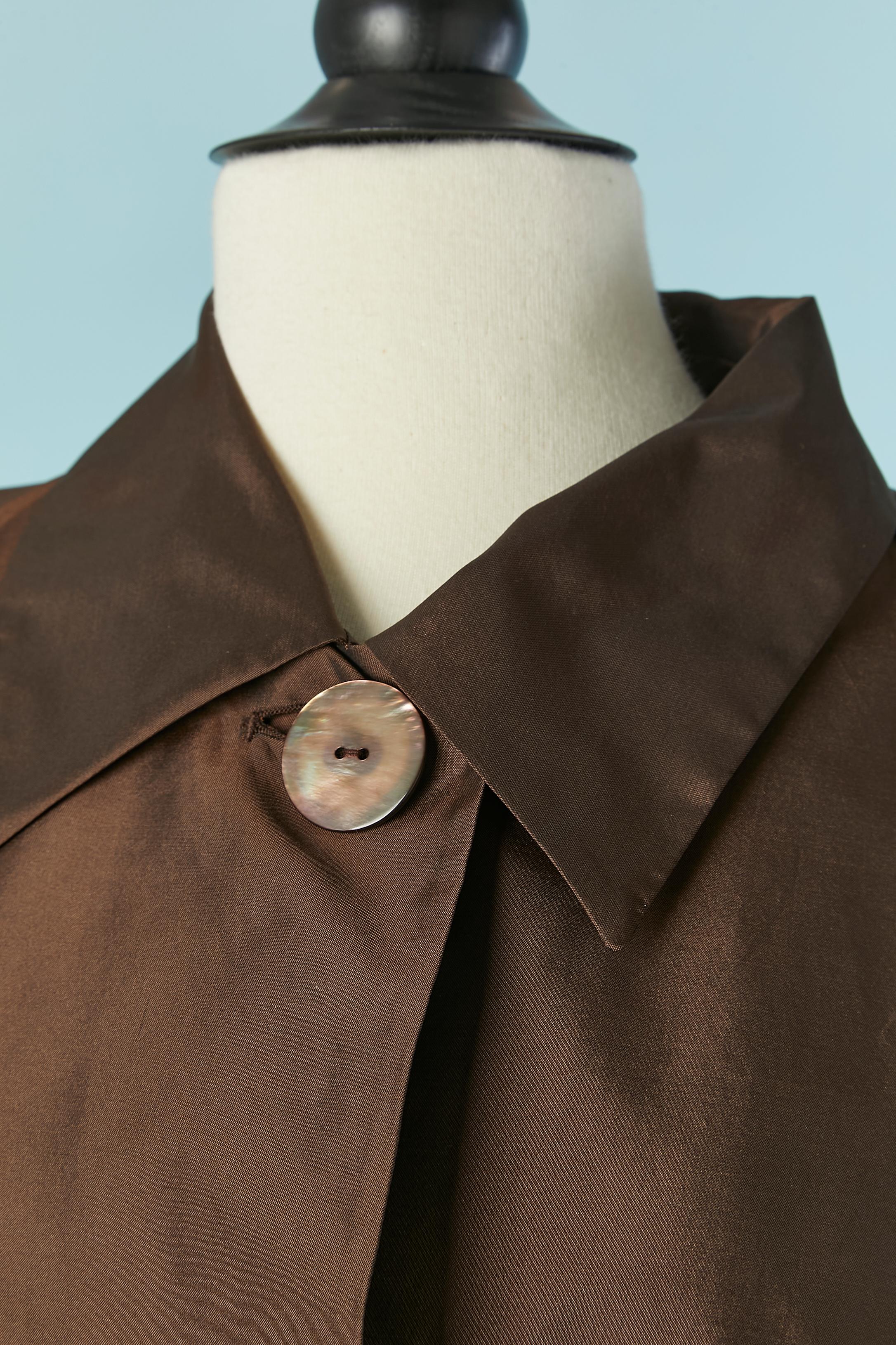 Silk and polyester brown A Shape coat . Fabric composition: 63% polyester, 37% silk. Lining composition: 100% rayon. 
Extra thin padding inside. One mother-of-shell button and buttonhole closure on the top middle front. Pocket on both side. Split on
