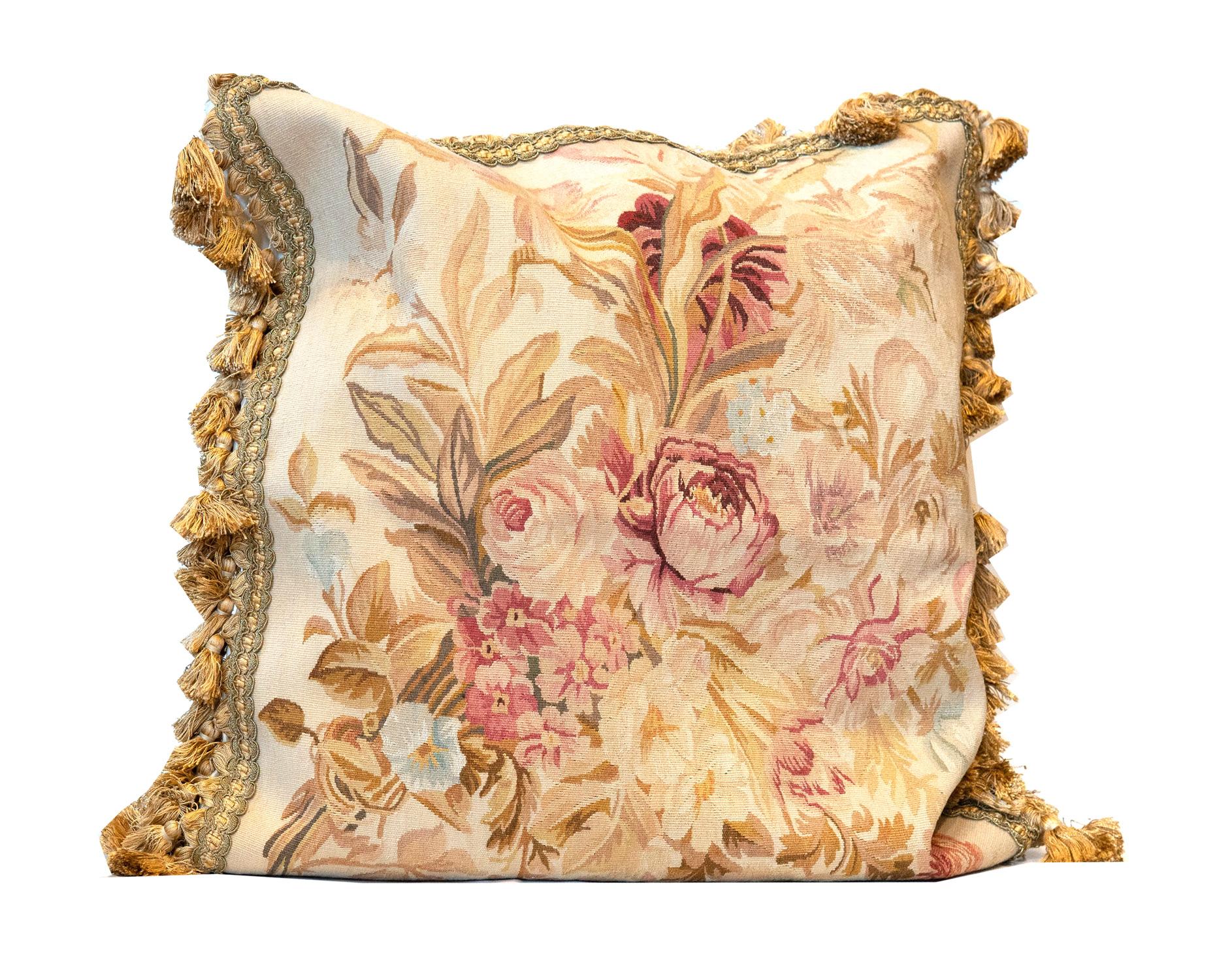This elegant handmade cushion cover has been woven with the finest materials with a fantastic floral design. The flowers have been incorporated in cream, beige, and pink accent colours on a subtle background and finished with a delicate pom-pom