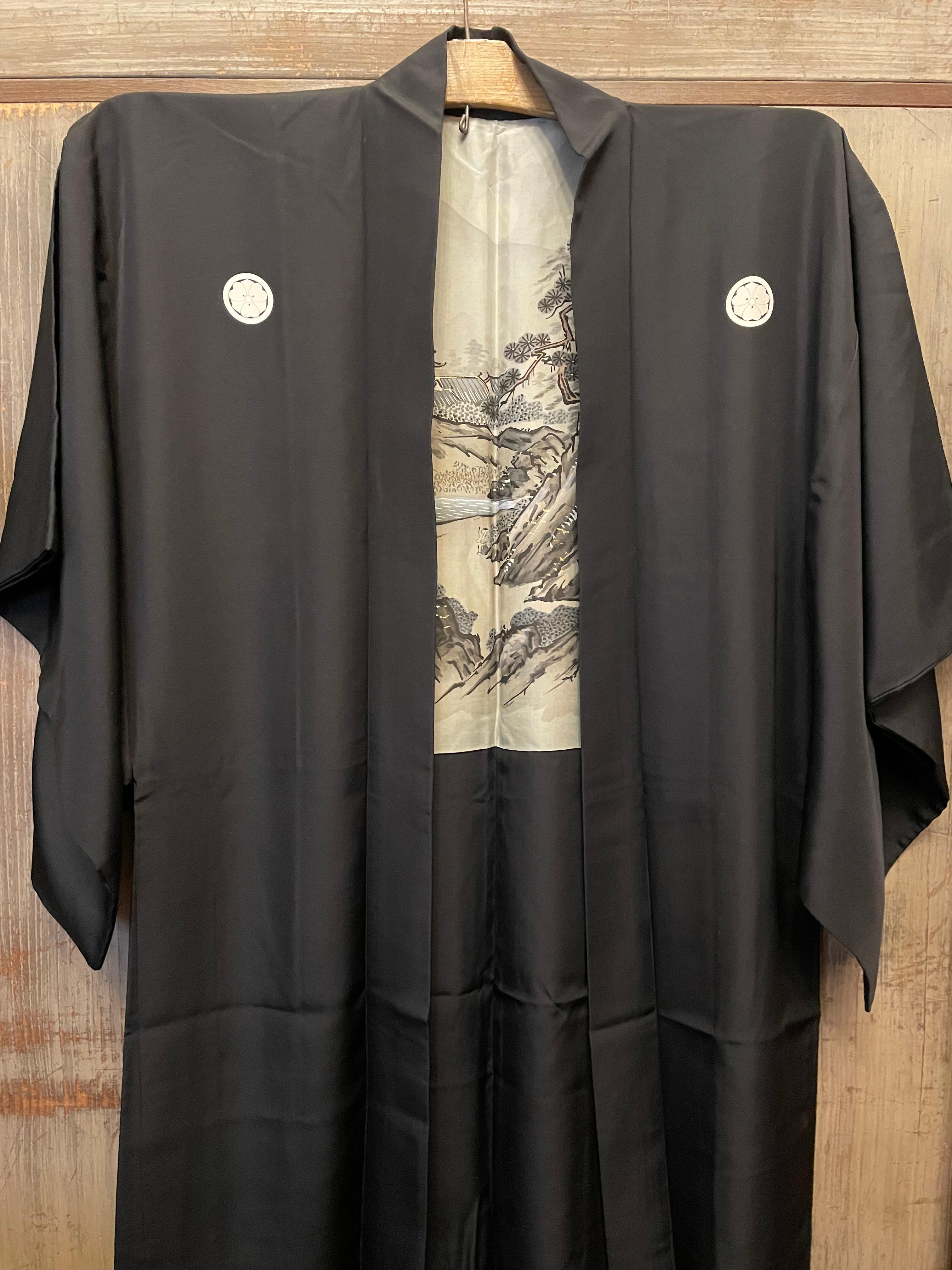 This is a Japanese Haori jacket for men made in 1960s (Showa era) and made with silk.
It is reversible. Inside of this haori, the design is with landscape, this design was drew by an artist 'Sesshu Toyo'. Outside is with family crest. 
The family