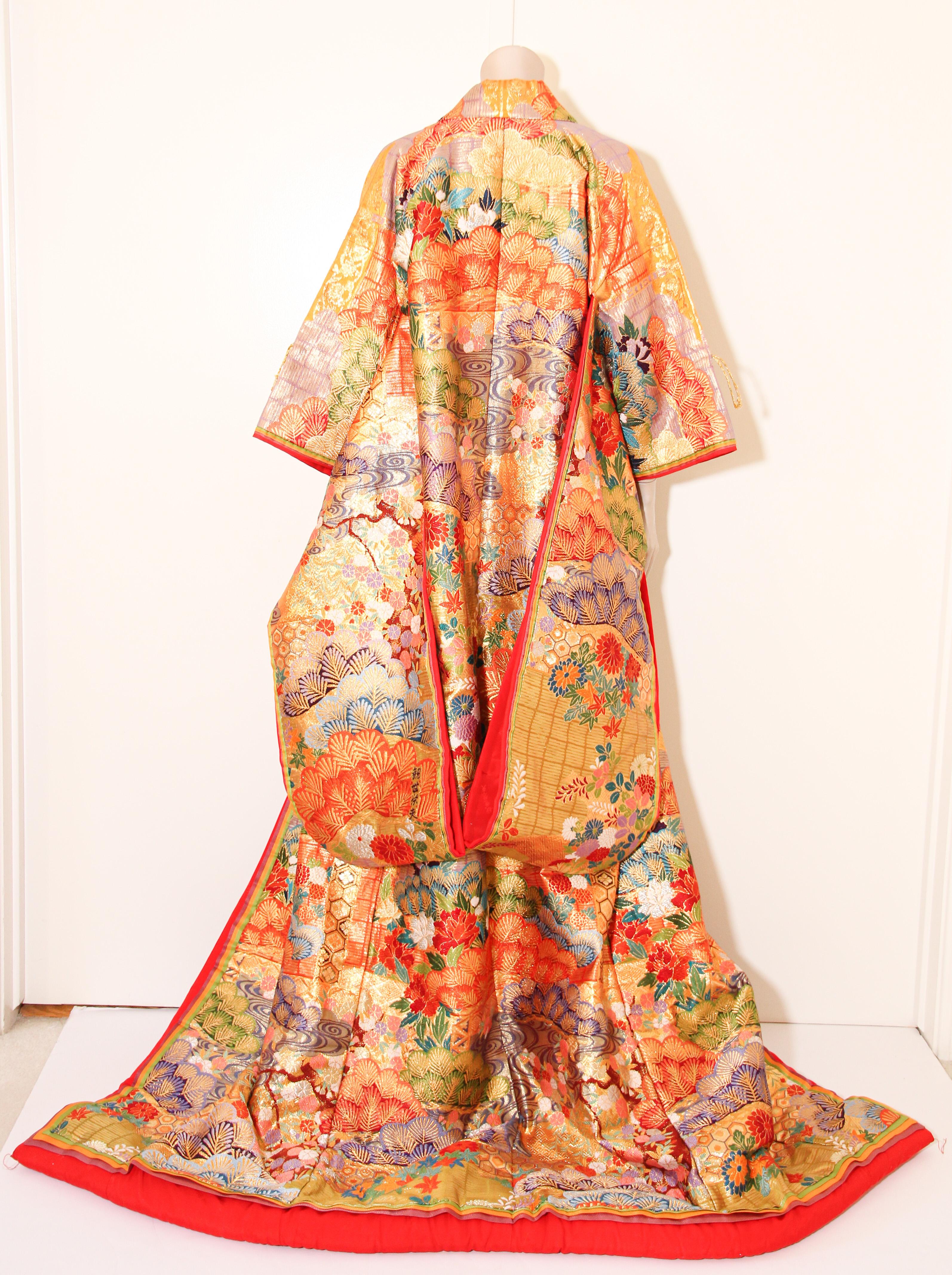 A vintage color silk brocade collectable Japanese ceremonial wedding kimono. 
Vintage heavy, signed by the maker, one of a kind handcrafted.
Fabulous museum quality ceremonial piece in pure silk with intricate detailed hand-embroidery throughout,