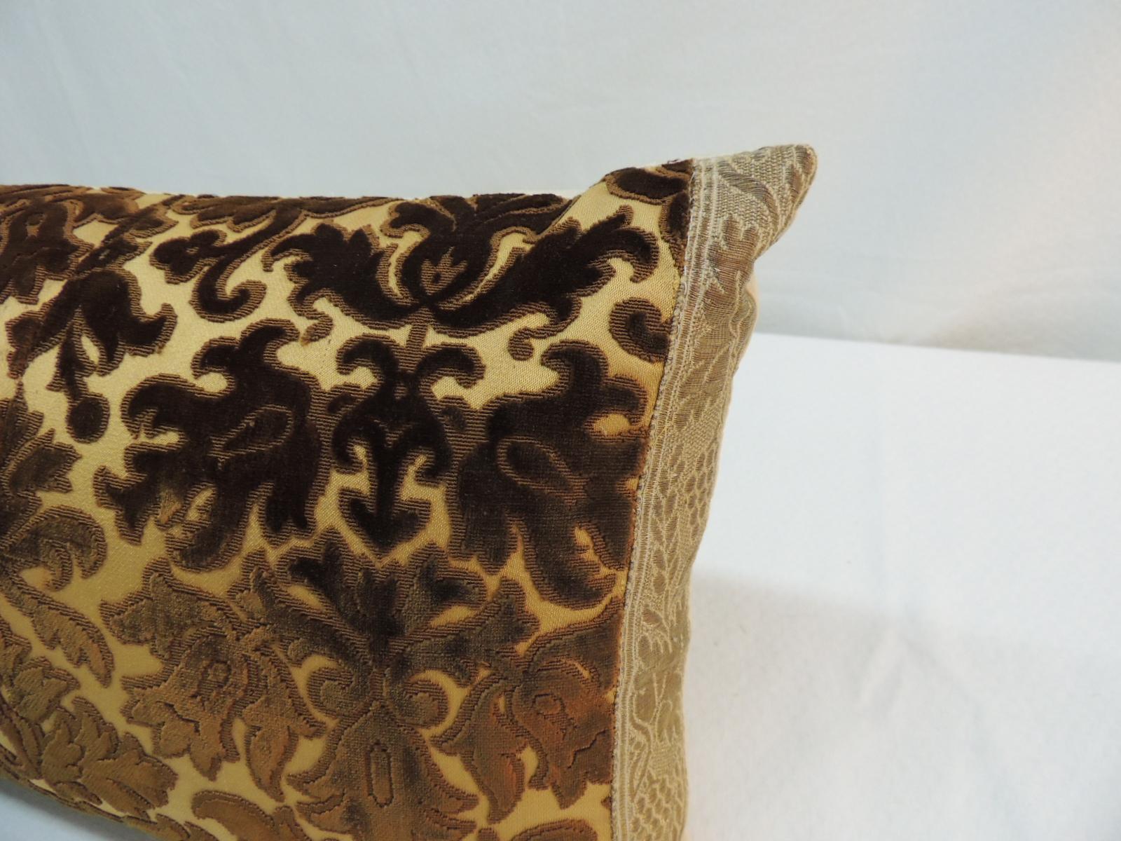 18th century silk brown velvet bolster decorative pillow framed with an 18th century gold metallic trim. The front antique panel of this decorative pillow has been carefully lined to add strength and durability to the antique velvet bolster pillow.