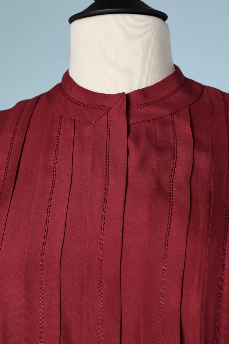 Silk burgundy shirt with top-stitched pleats on the front. 
The cuff need to be close with cufflink ( not provided)
SIZE M