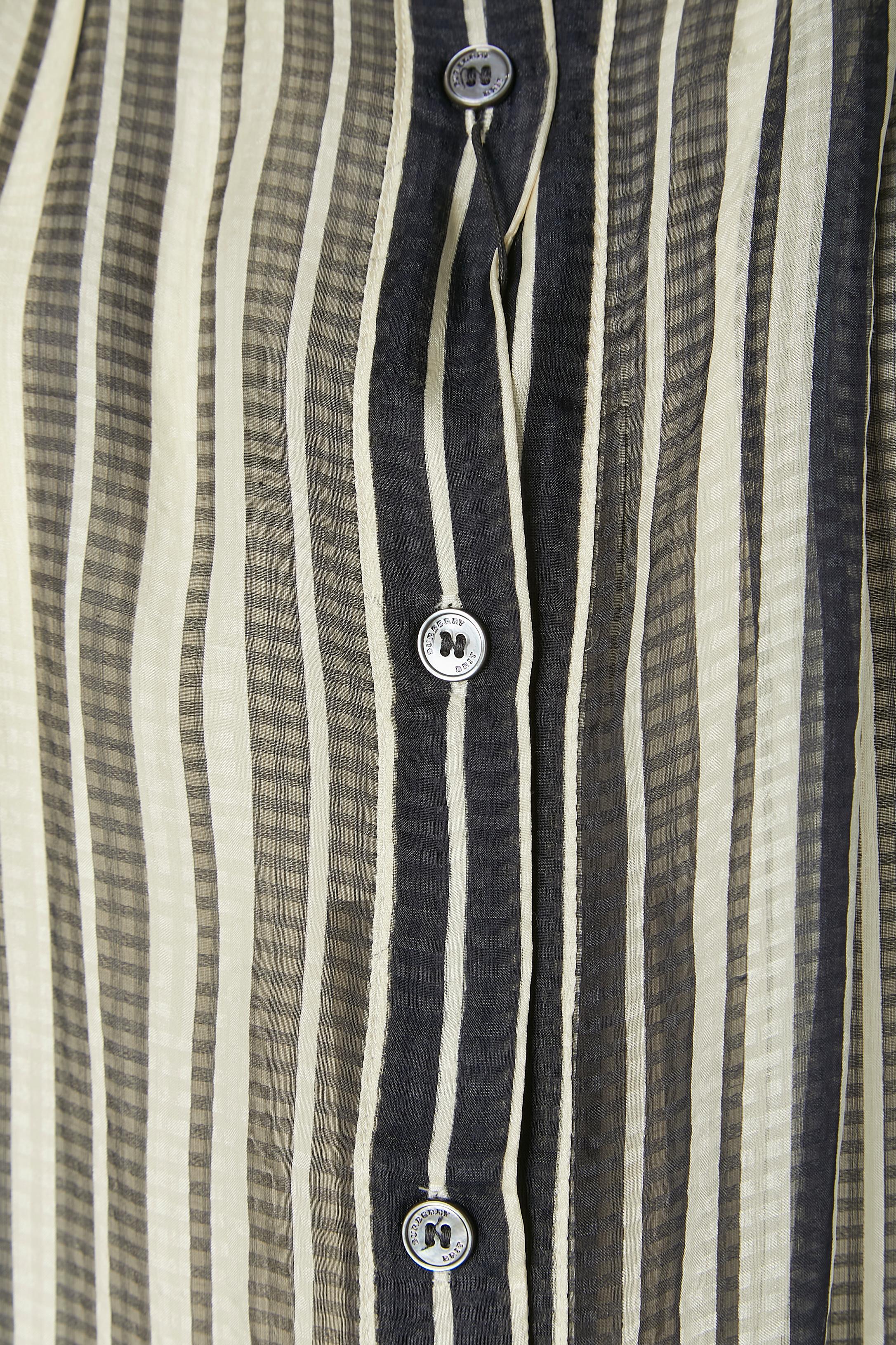 Silk chiffon striped shirt with branded button closure on the top middle front and on the cuffs. One extra button provided.
SIZE XS on tag but fit more likely M / L 
