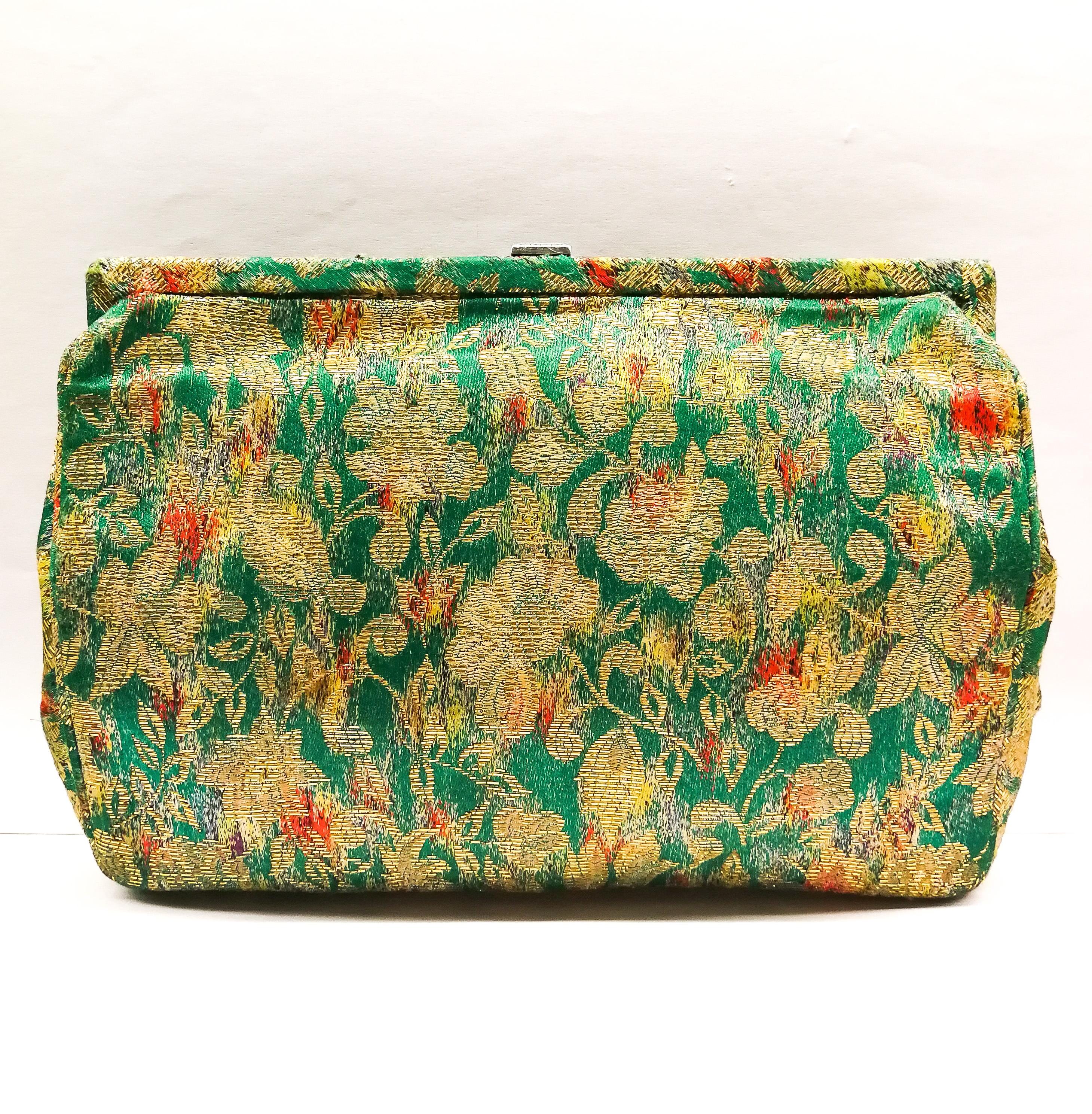 A ravishing, unique and highly decorative clutch bag, in green and red silk lame fabric, shot through with gold, with a very large silver, marcasite and green crysoprase clasp, that lifts to open. When opened, the interior is lined in turquoise and