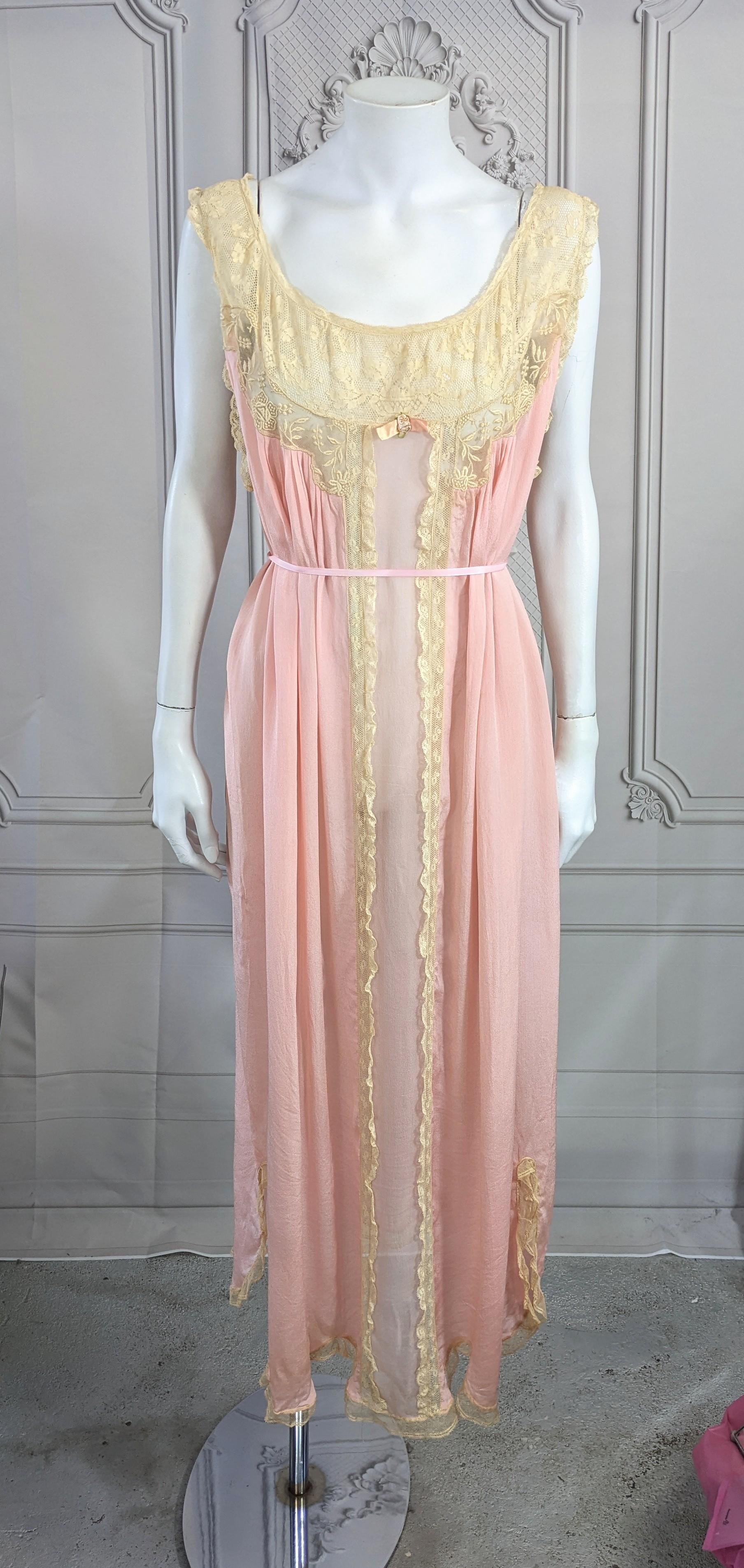 Lovely Silk Crepe, Chiffon and Lace Gown, retailed by I. Magnin in the 1920's. Antique lace inserts on pink silk crepe body with sheer chiffon front panel and ruffled lace trim. Full cut tubular shape. Large size. 1920's French import. 