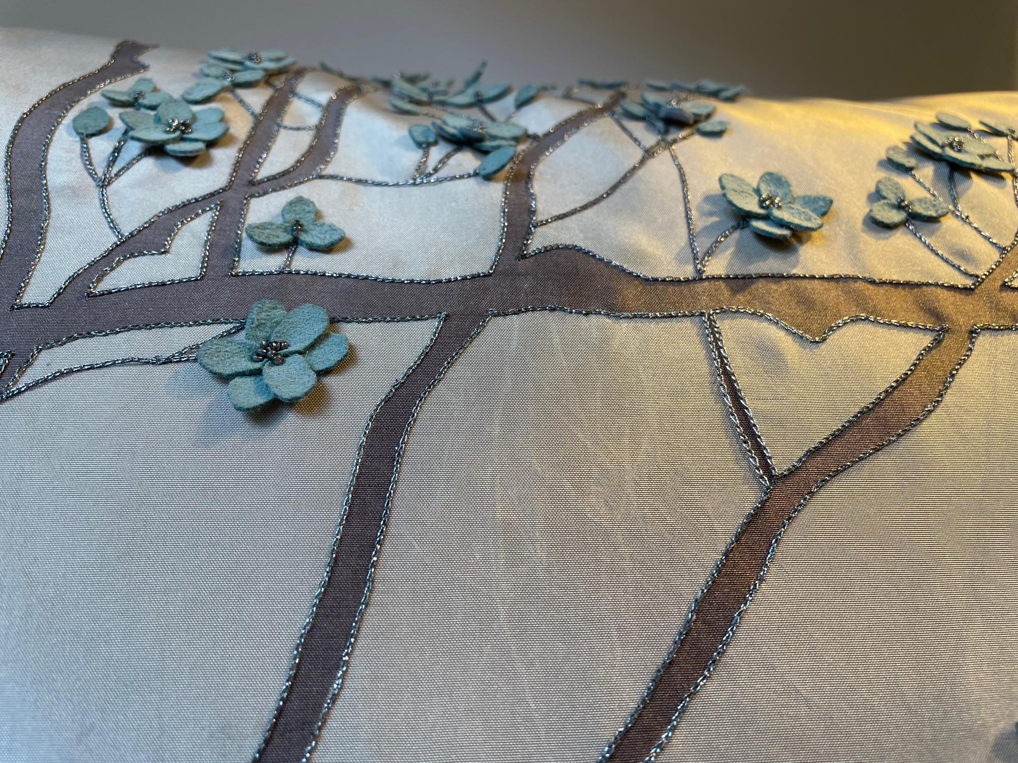 Silk Cushion col. sand with hand embroidery and hand painting, The painted branches have a silver thread hand embroidery outline - the blossoms are made from suede with silver beading, the cushion had been used as showroom sample,
the plain back
