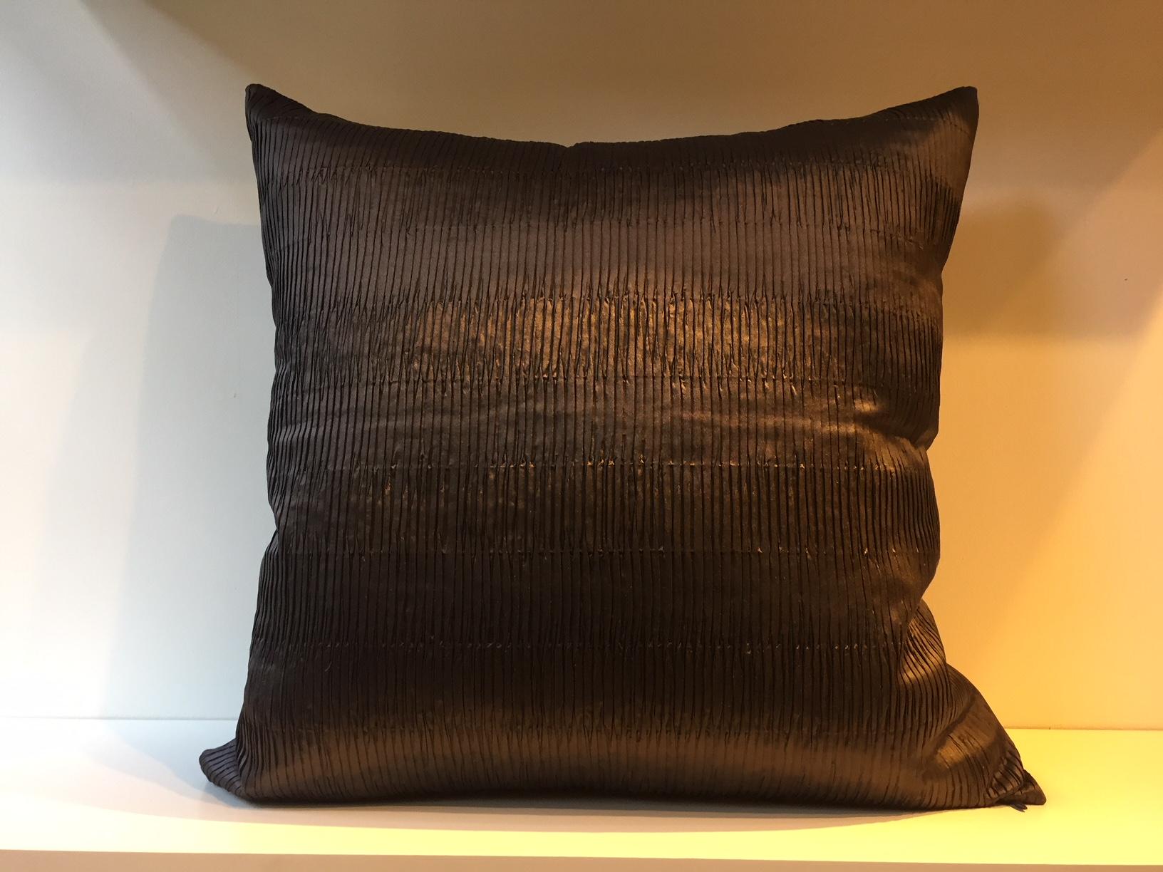 One pair of silk cushions with embossed front panel in steam pleated pattern color brown, front panel silk taffeta hand woven, back panel plain hand woven, heavy silk in matching color, cushion size 53 x 53cm, concealed zipper in the bottom seam,