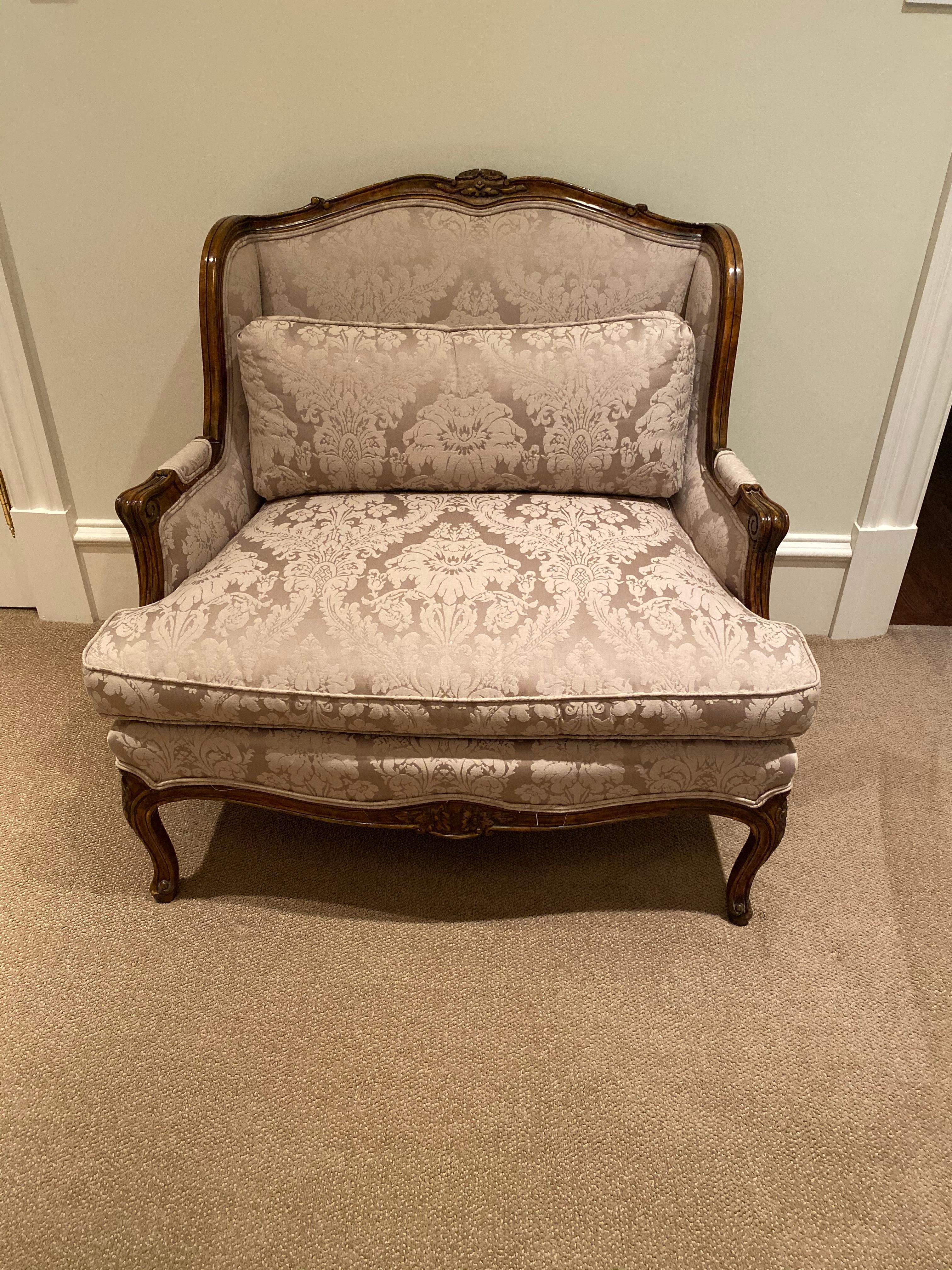 Large bergere chair in silk damask
Beautifully polished wood frame, with lovely detail
This large accent chair has curved legs, stately shape, neutral and elegant silk damask upholstery and accent pillow
perfect in your living room, boudoir or
