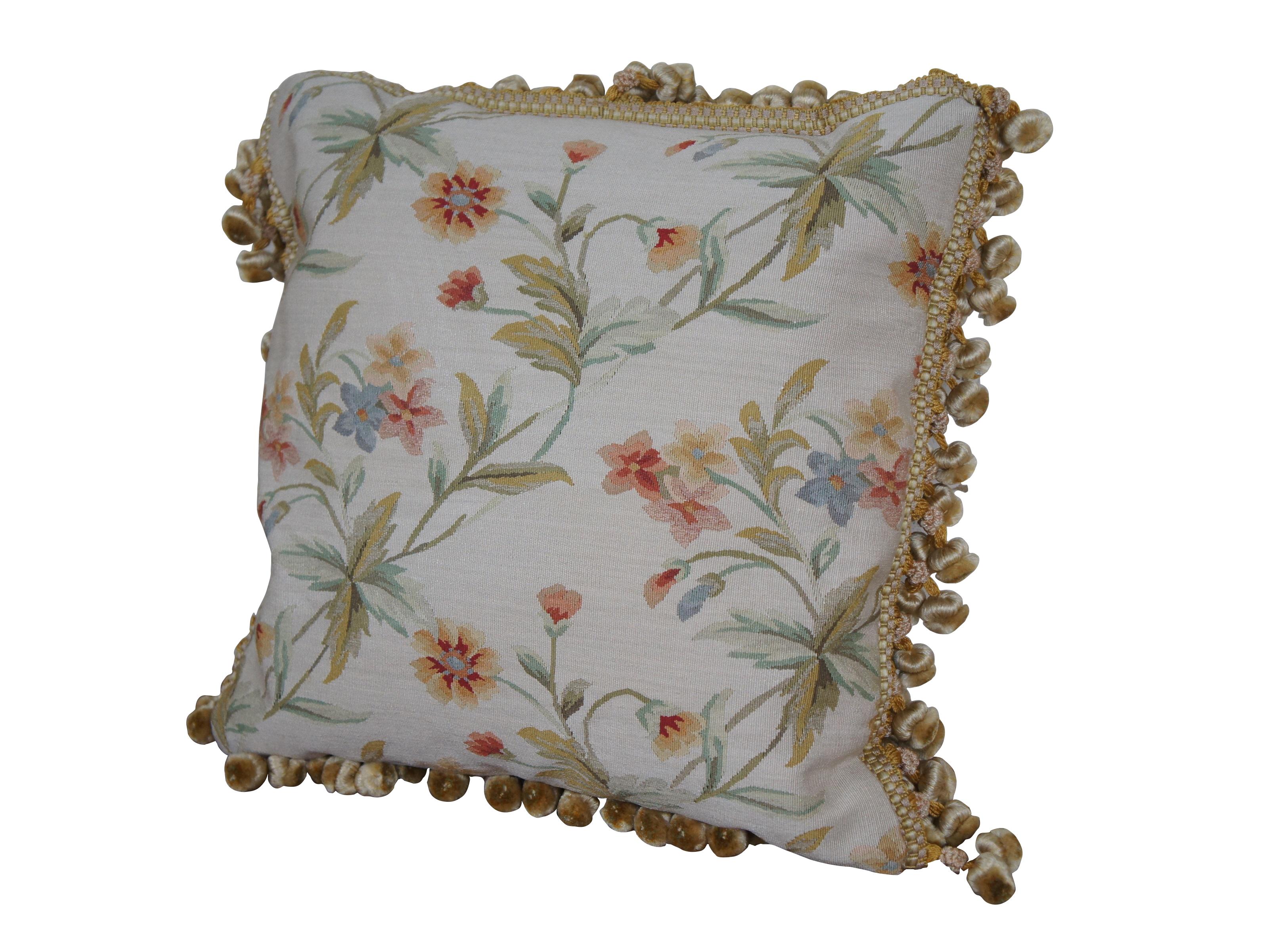 2 Available - 20th century square throw pillow, embroidered in silk with an array of cream, rusty pink, and blue flowers on green leafy stems. Gold and cream tassel trim. Light brown velour back with zipper closure. Down filled.

Dimensions:
16
