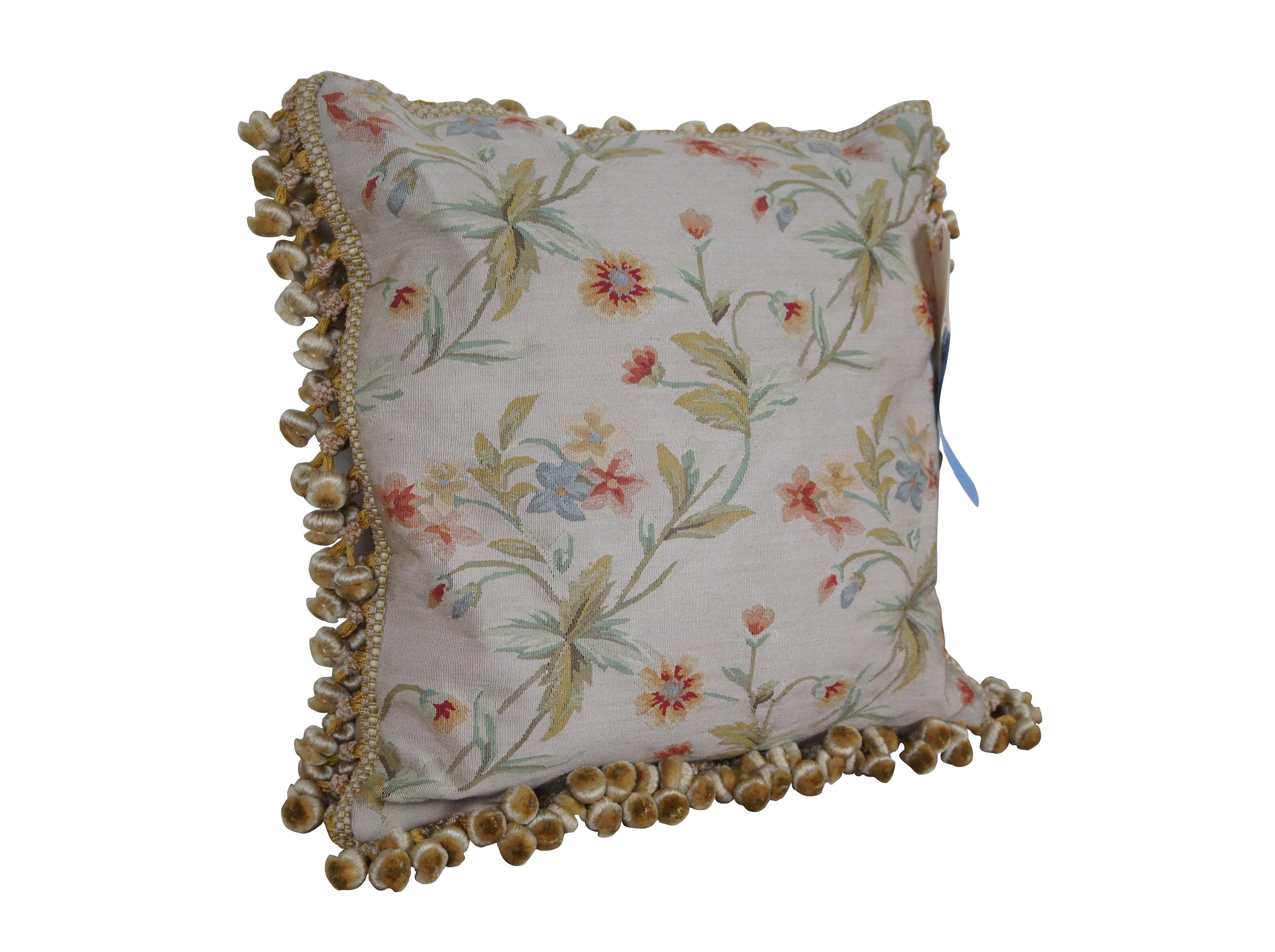 2 Available - 20th century square throw pillow, embroidered in silk with an array of cream, rusty pink, and blue flowers on green leafy stems. Gold and cream tassel trim. Light brown velour back with zipper closure. Down filled.

Dimensions:
18