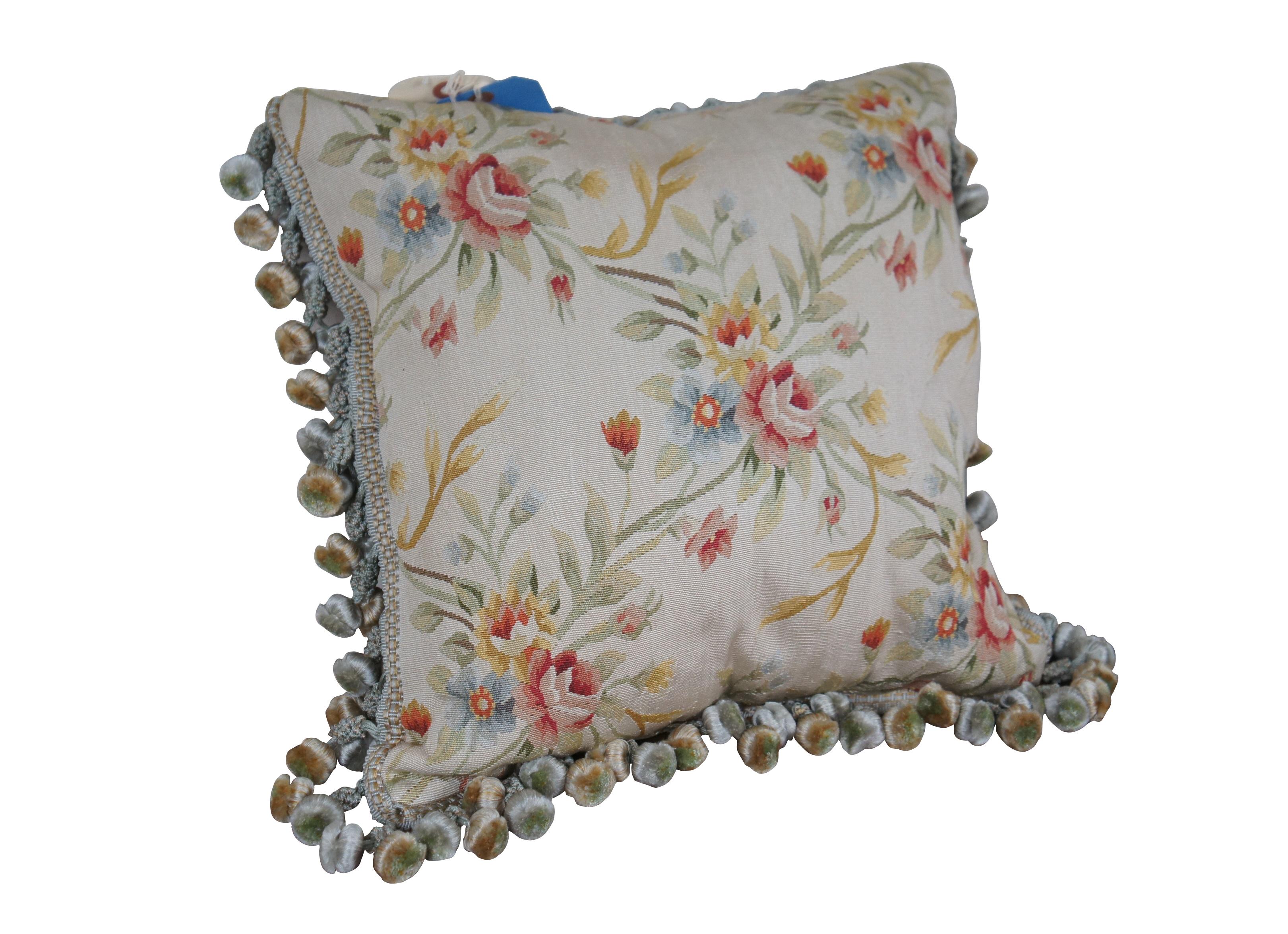 20th century square throw pillow,  embroidered in silk with bouquets of pink, yellow, blue and orange flowers, connected with green and yellow stems. Down filled. Light brown velour / velvet back with zipper closure. Blue and gold ball tassel