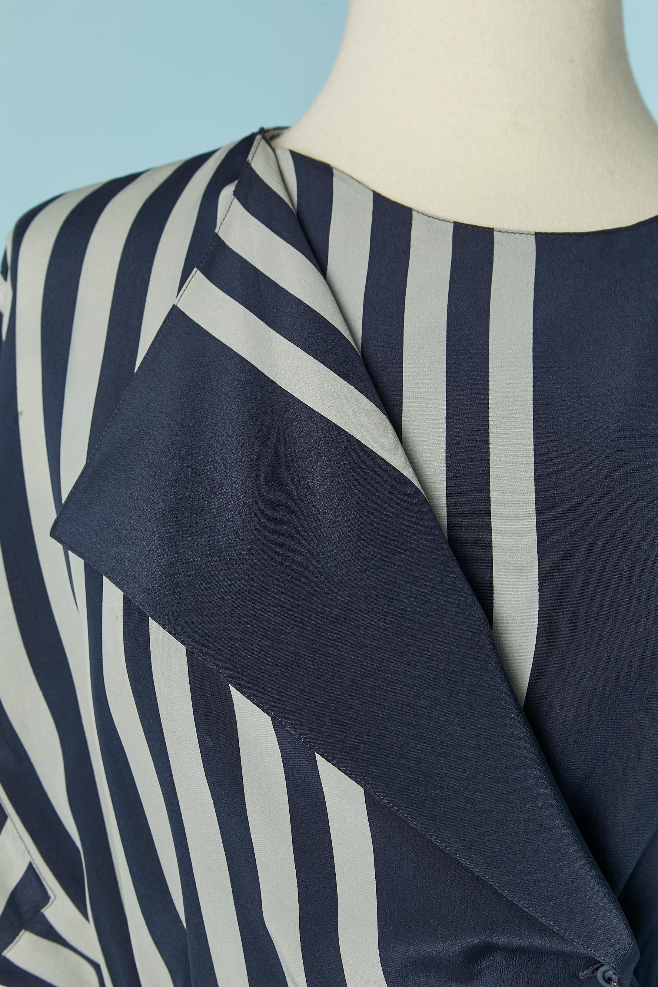 Silk dress with striped pattern. One button and buttonhole on the top right on the front. Belt-loop. Elastic band on the waist. 
SIZE 40 (Fr) 8 (US) M 