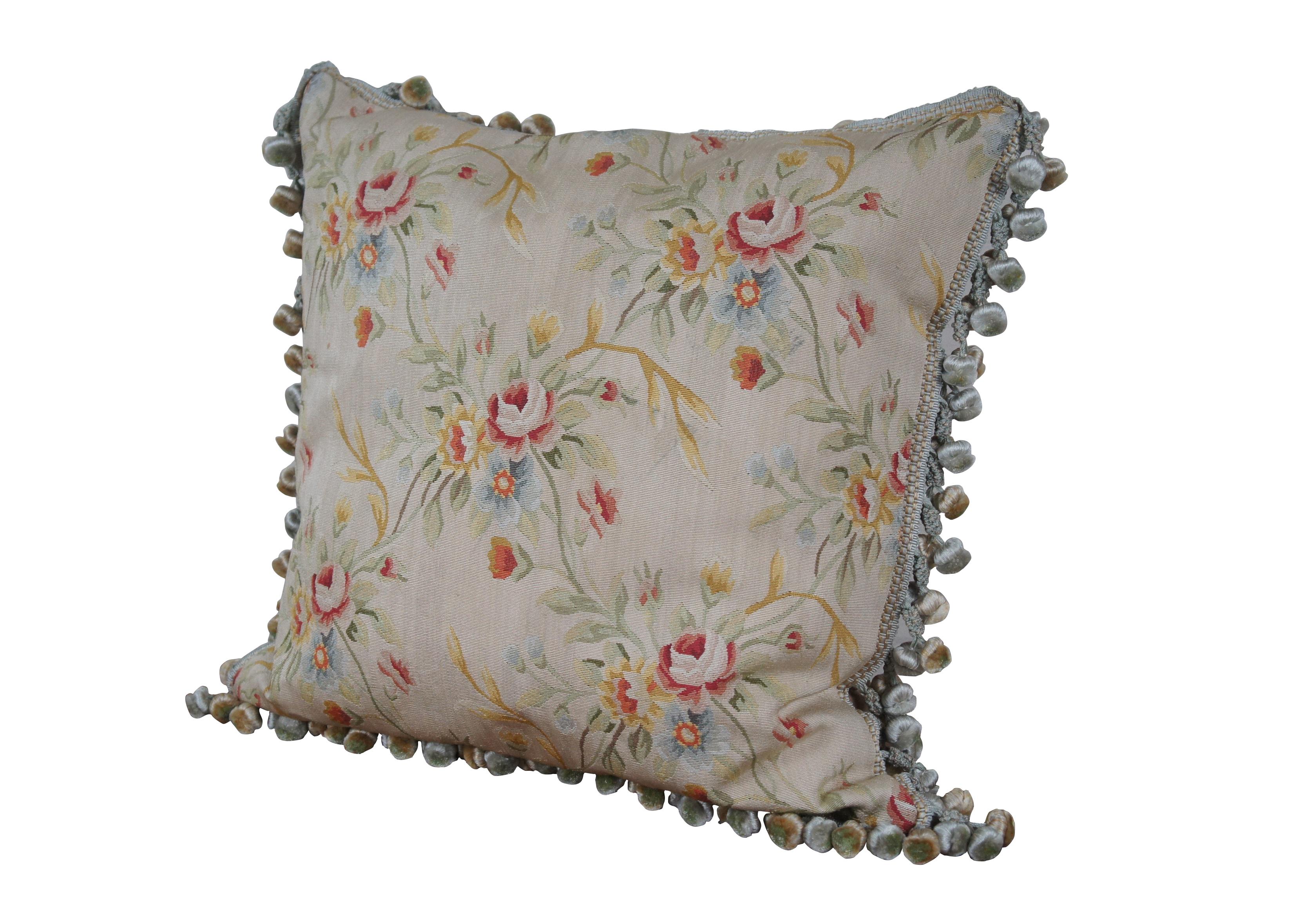 20th century square throw pillow, embroidered in silk with bouquets of pink, yellow, blue and orange flowers, connected with green and yellow stems. Down filled. Light brown velour back with zipper closure. Blue and gold ball tassel