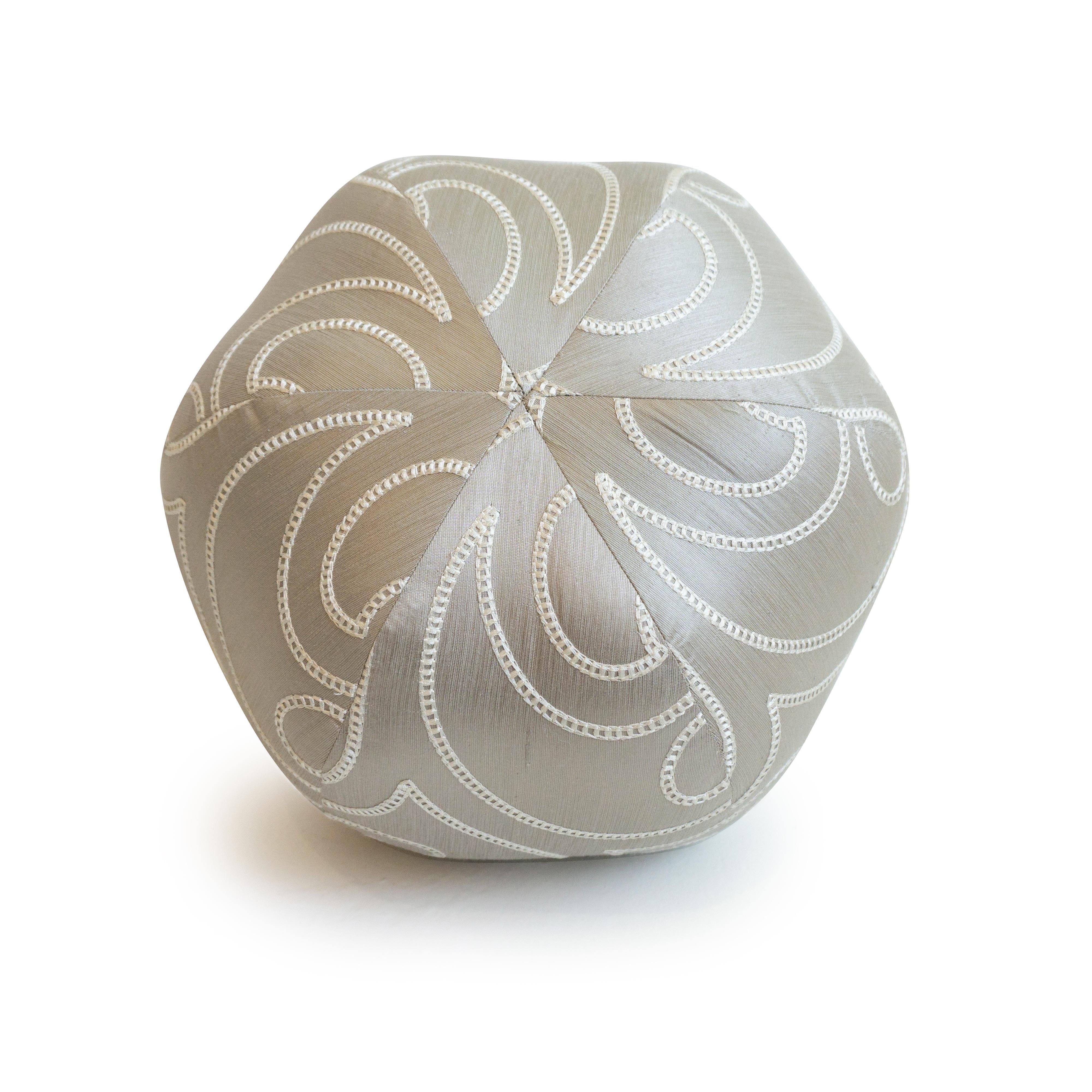 A handmade silk pewter colored ball pillow with a white embroidered pattern. Hand sewn in our studio in Norwalk, Connecticut. 

Measurements: 9