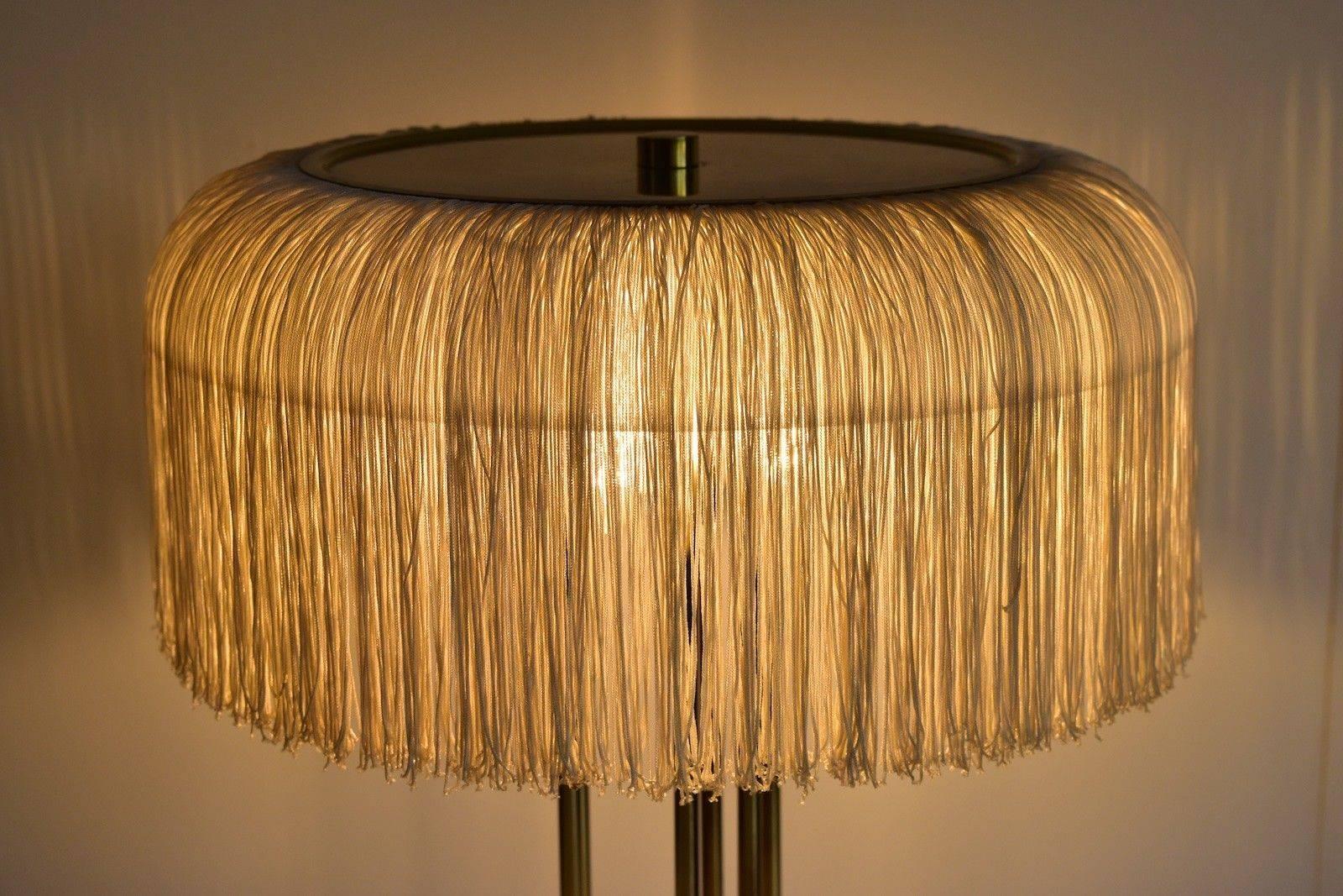 Nice silk fringe table lamp in the manner of Hans Agne Jakobsson lamps. Base in brass with three E14 sockets. One crack at the plastic shade but this is under the fringe so not to see. Makes a very nice light.