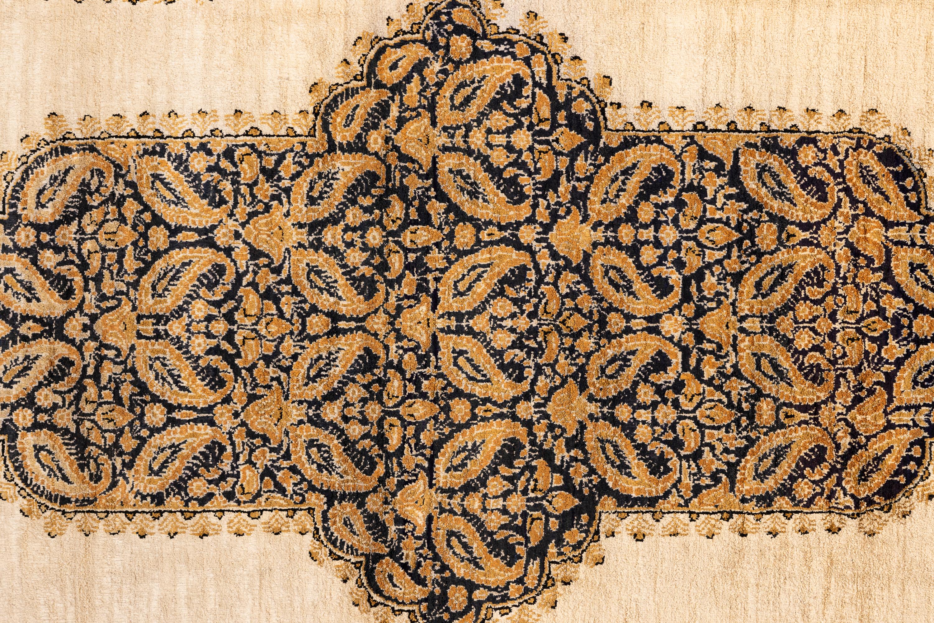 Ghom Silk– Northwest Persia

Fine silk Qom carpet. The ivory field has a large floral medallion with two pendants formed by large botehs interconnected with flowering vines. The pale dusty-pink border has double botehs and open floral sprays between