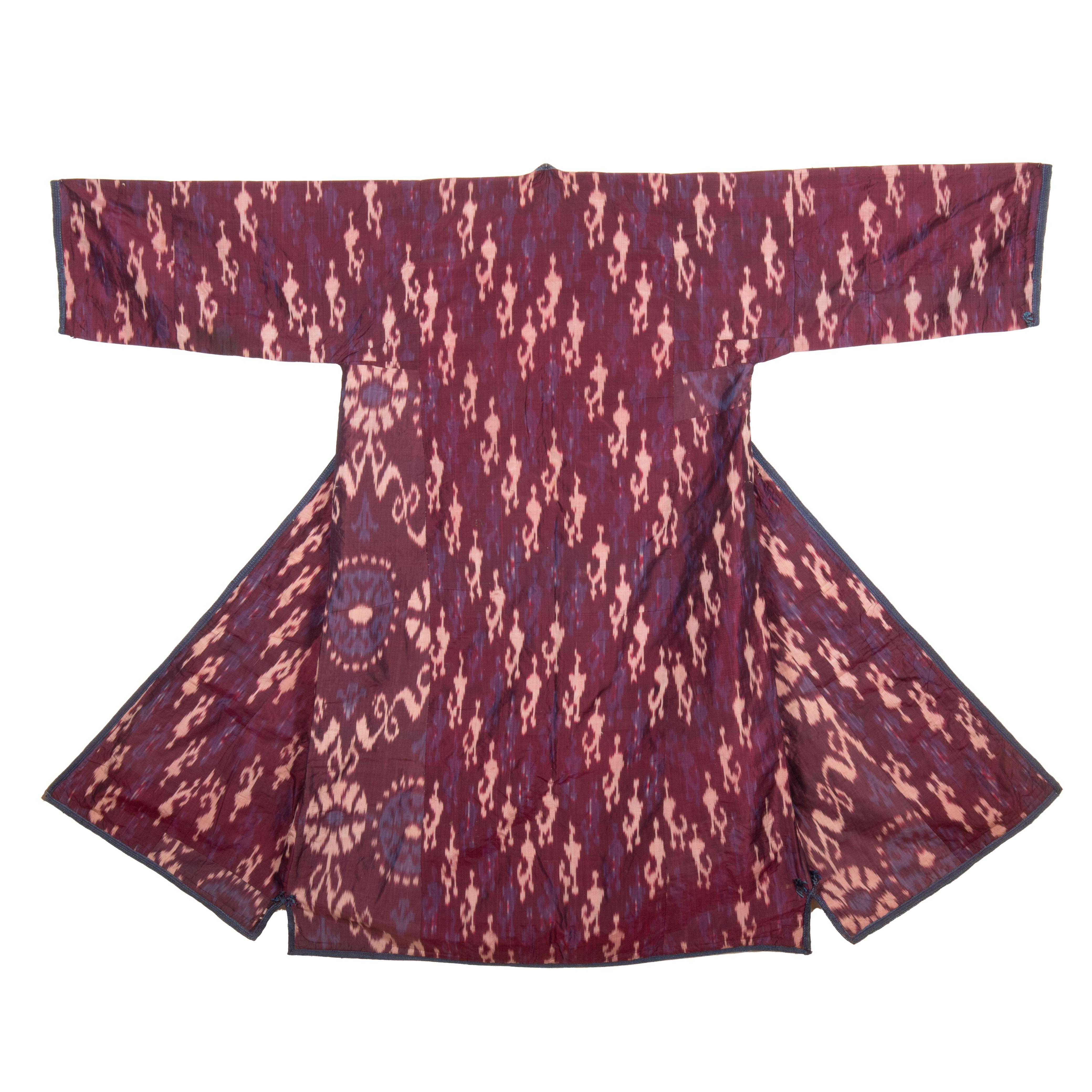 A Silk Ikat Chapan from Uzbekistan is a traditional robe or coat made of silk fabric, adorned with intricate ikat patterns. 