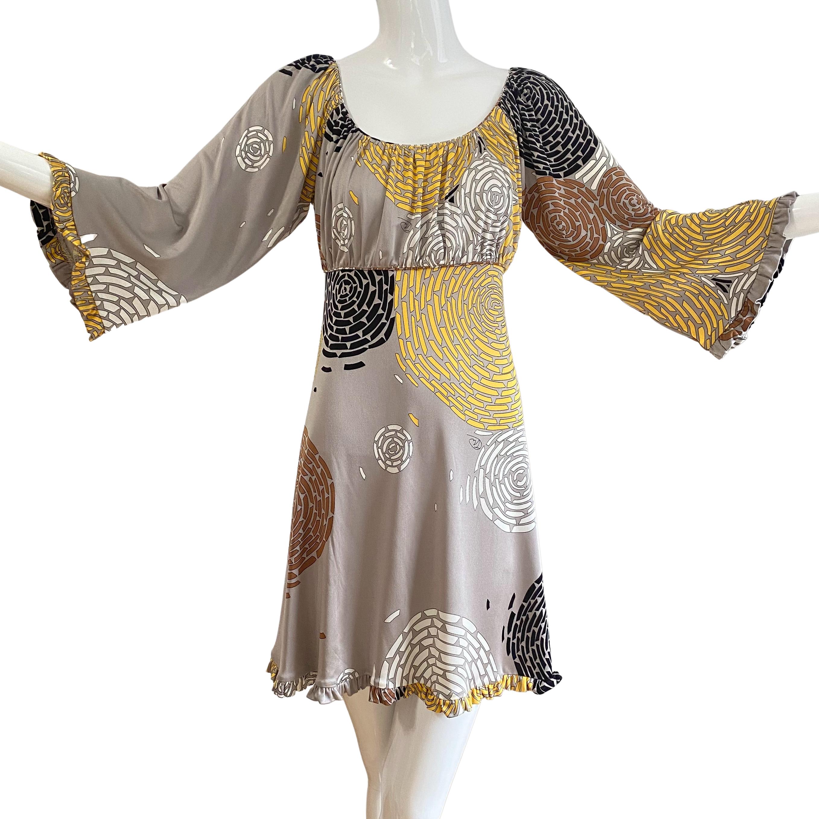 Generous shirred bust, ruffle at 3/4 bell sleeves and flared skirt.
Ties front or back for a perfect fit.
In Flora's hand-signed, stylized chrysanthemum print. 
One of Flora's favorite dresses!
Approximately 36