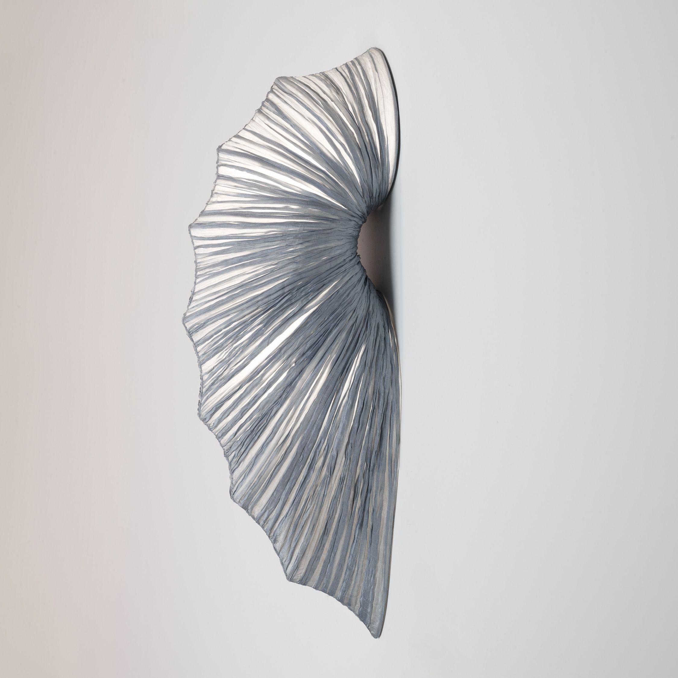The Contrare's organic figure was inspired by natural forms as well as modern sculpture and architecture. The Contrare wall fixture adds a touch of sophistication to any interior. The Contrare Wall Light is part of the Orchestra Family, which takes