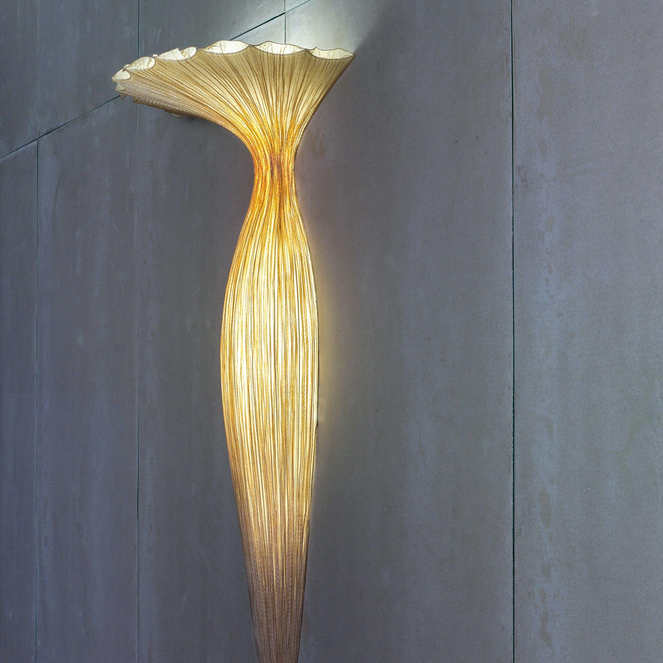 As its name suggests, the evening glory wall fixture comes alive like a night-blooming flower. This luminous artwork is part of the morning glory family, including our most iconic lighting collection. Made by hand of crushed silk and metal. It casts