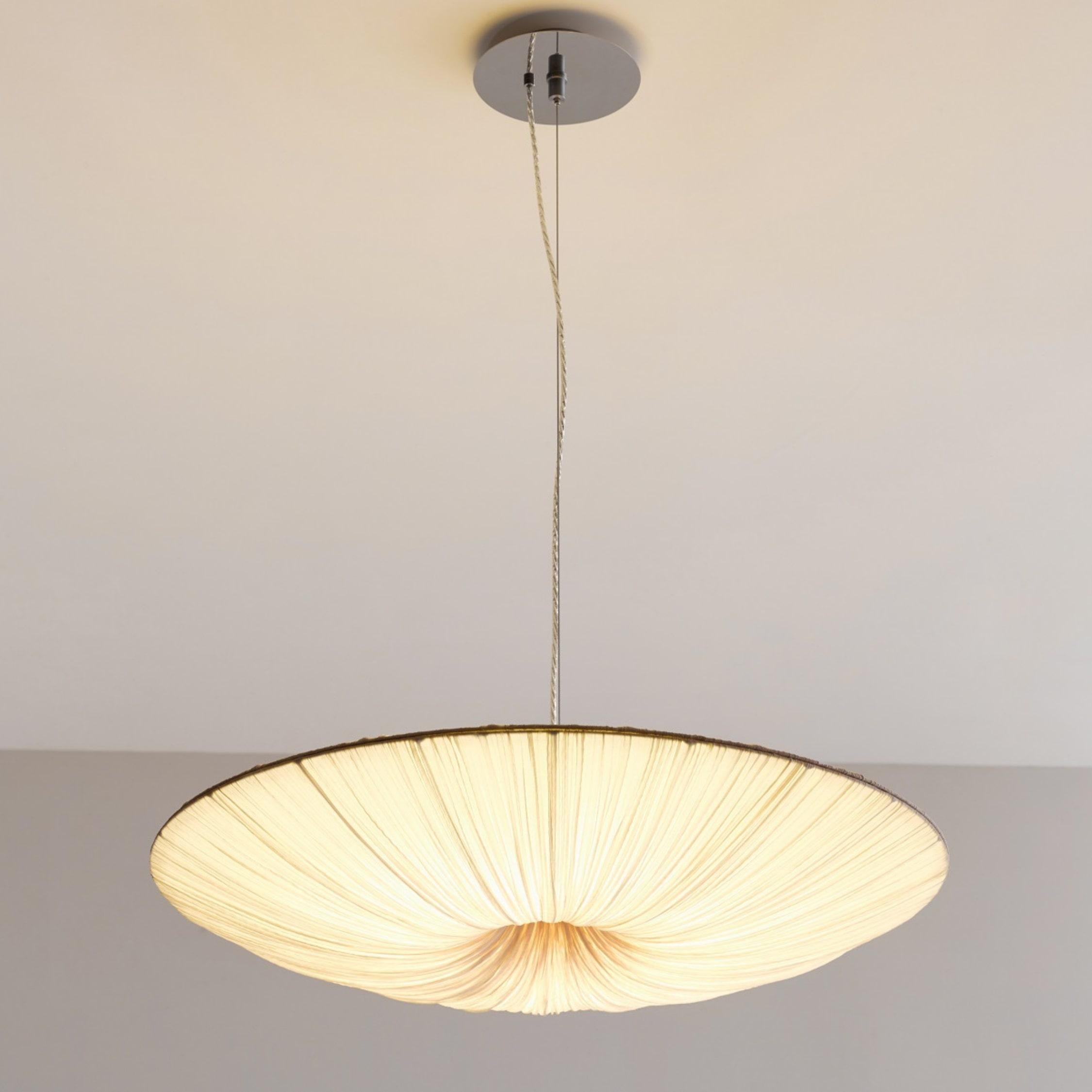 The Stand By pendant light is a perfectly round shaped disc featuring a combination of pure simplicity and glamour. Stand By radiates Brilliant light across large areas and adds character and a unique refinement to any space. Measure: 60cm / 24