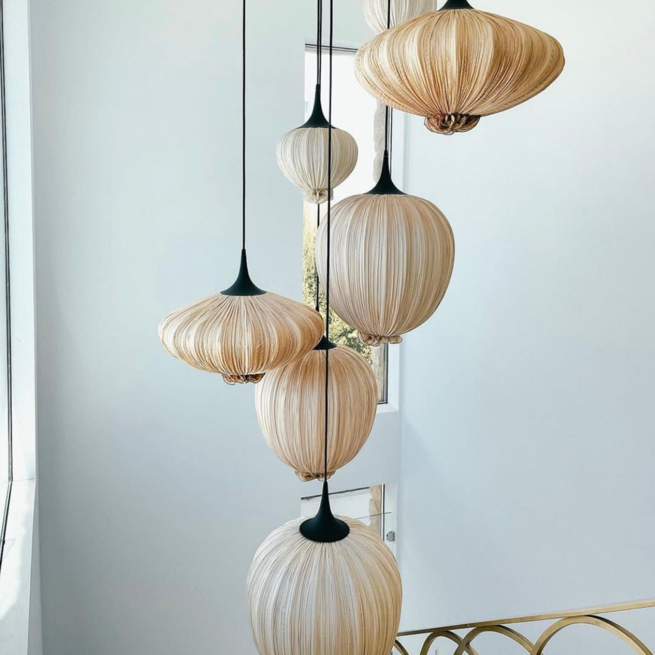 Orb shaped pendant light hand made by hand form crushed silk on metal.