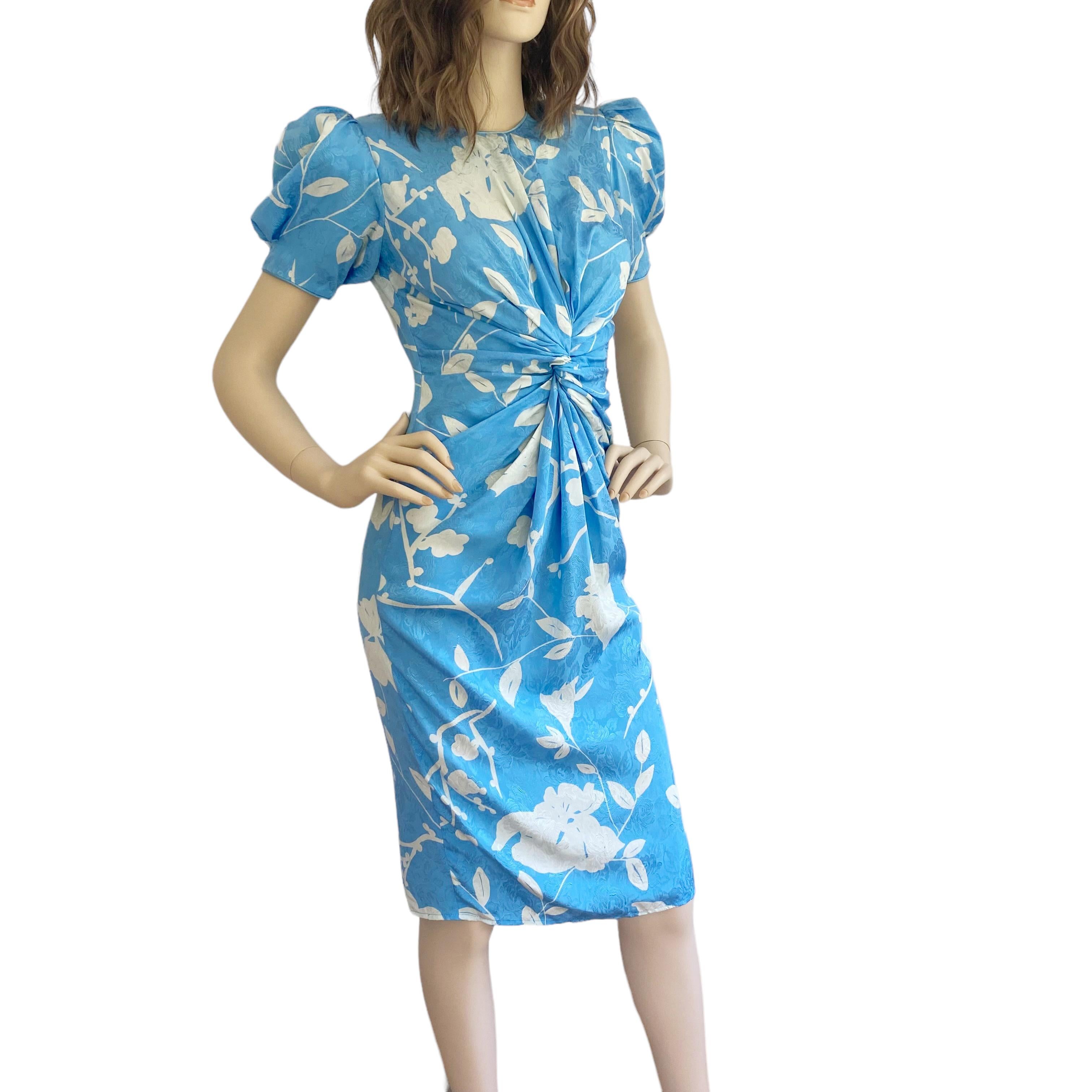Flattering dress with puff sleeves and shoulder pads.
Invisible back zipper entry.

White floral printed on Flora's original-designed floral silk jacquard textile.
 
Tag reads 2 but can fit up to more sizes thanks to the cut.
Measures approximately