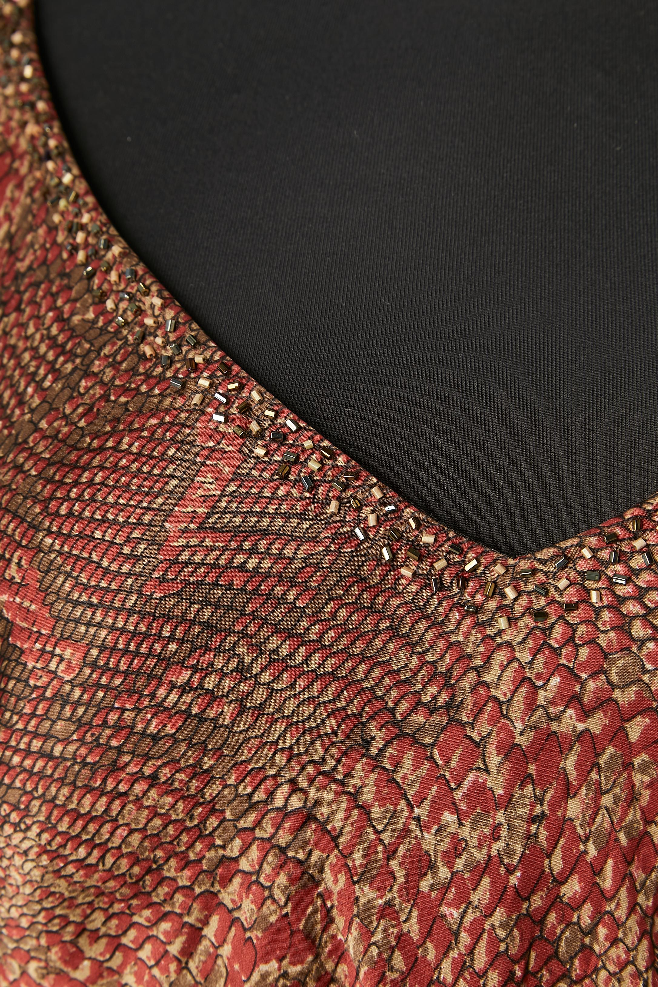 Silk python printed evening dress with thread fringes and beaded work. Rayon lining. Invisible zip on the left side and hook&eye. The fabric belt can be wear as a scarf as well. ( size 50 cm X 200 cm) 

SIZE 3 but fit M 