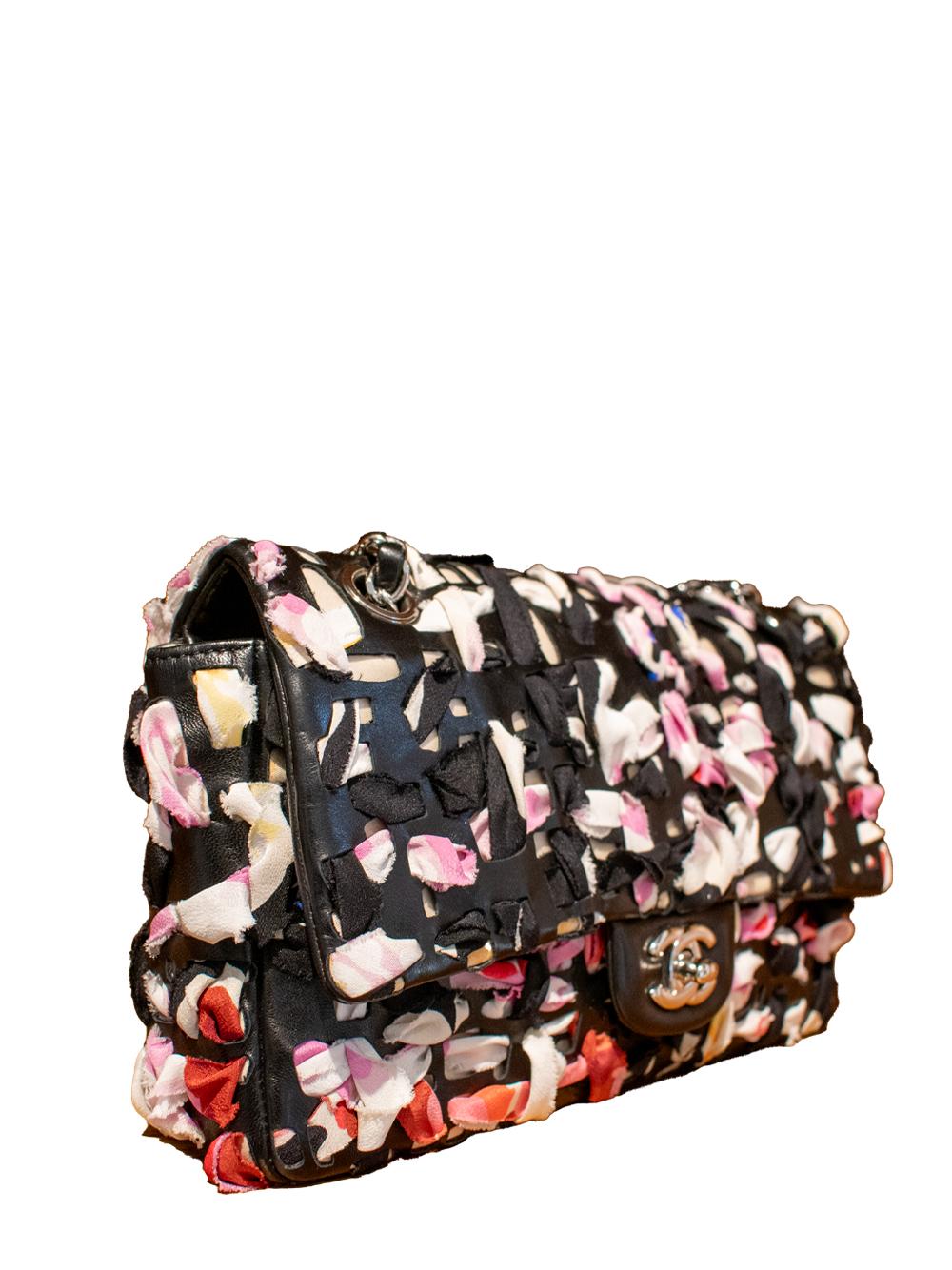 Elevate your style with the timeless elegance of the Silk Ribbon Classic Flap from Chanel. Crafted with luxurious silk ribbon in black and multi, this iconic piece exudes sophistication and refinement. Elevate your wardrobe with this statement