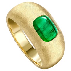 SILK RING Yellow gold with an emerald cabochon at the centre by Liv Luttrell