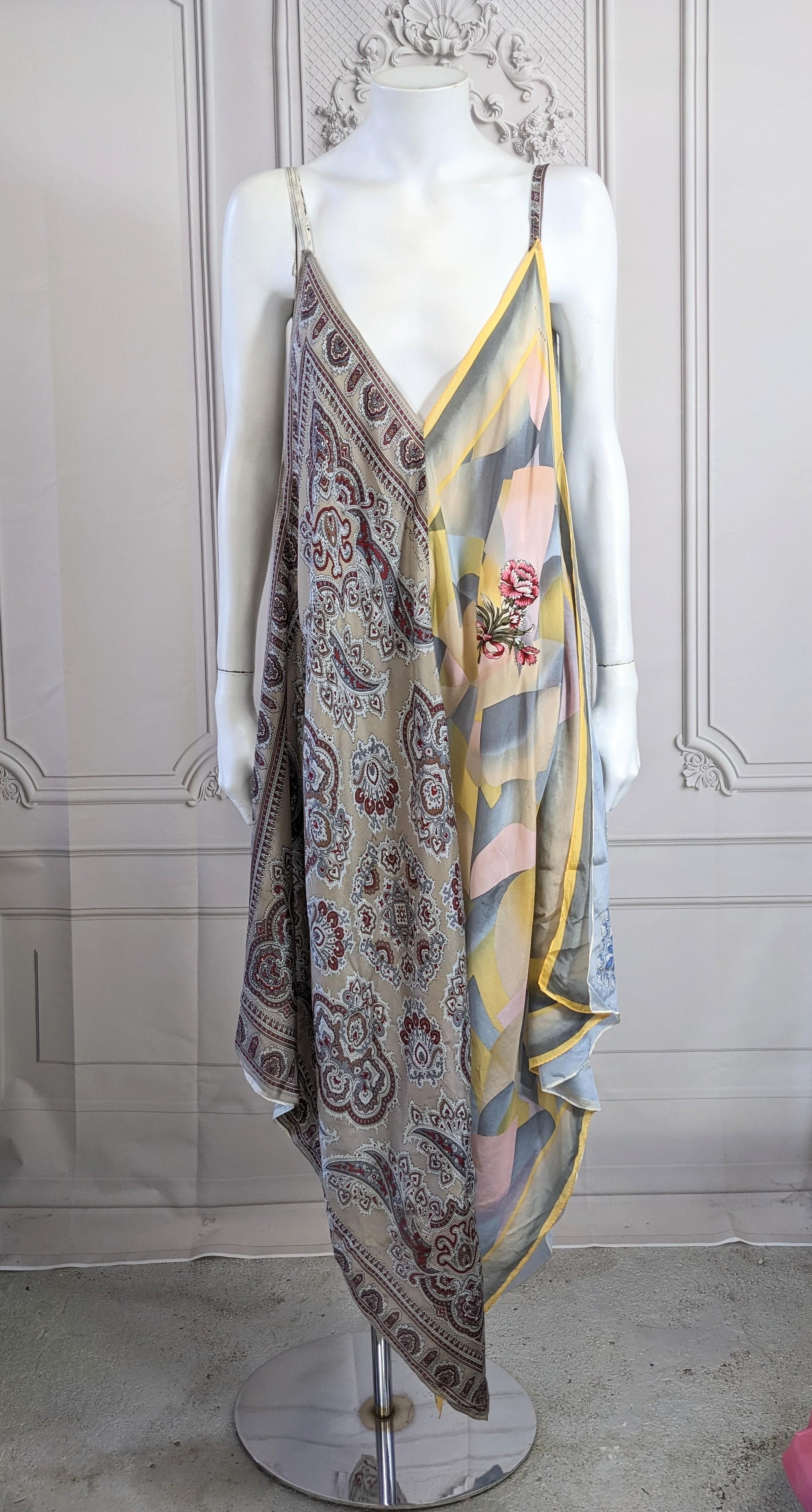 Silk Scarf Point Dress by accessories designer Elaine Gold circa 1990's. Made of 4 silk scarves, some of which appear to be vintage. Her signature is printed on the edge of one point and floral appliques cut from one scarf are added to the front. 