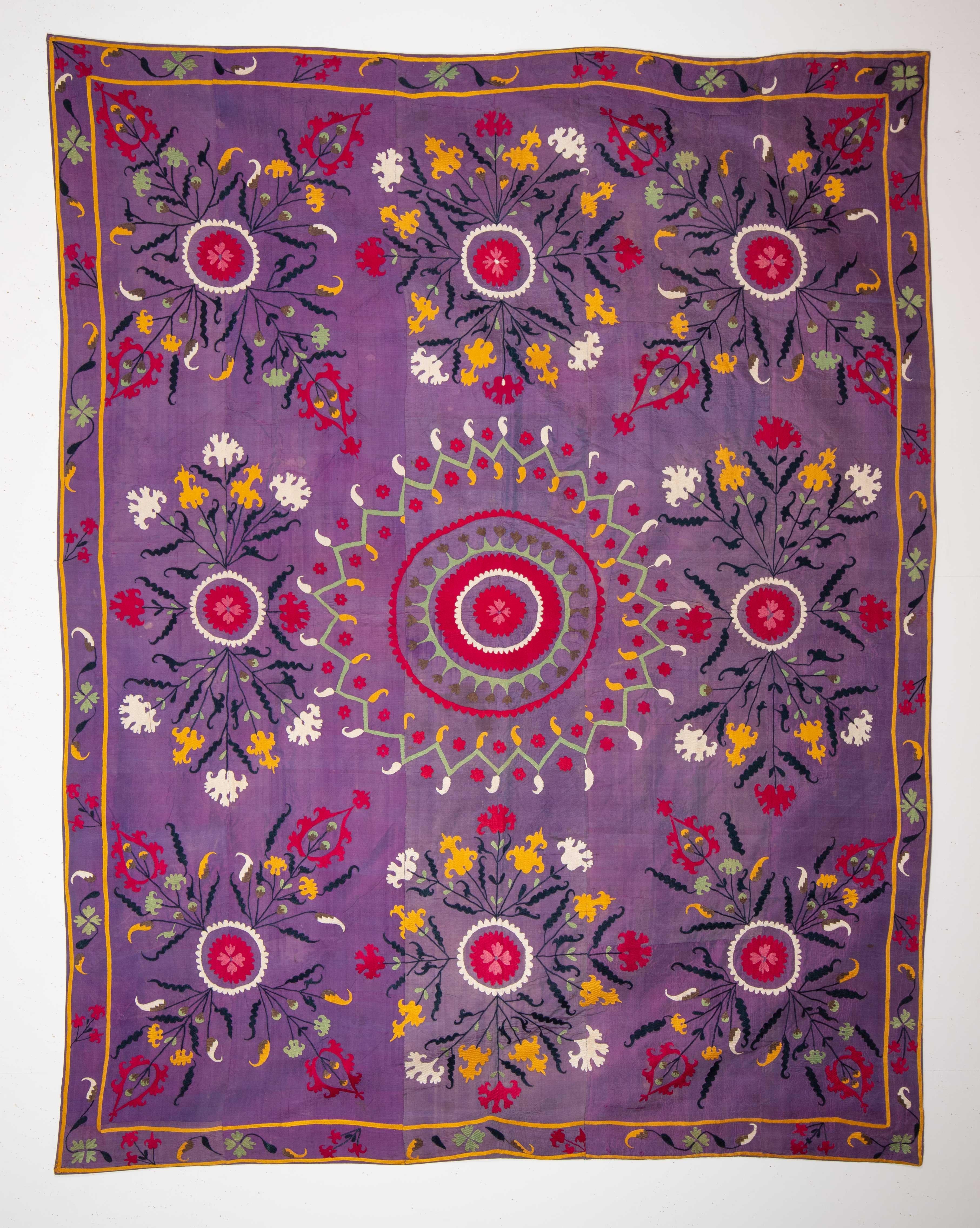 This suzani is embroidered on a silk background. It is an early 20th c example of probably Ferghana Valley suzanis in Uzbekistan.
