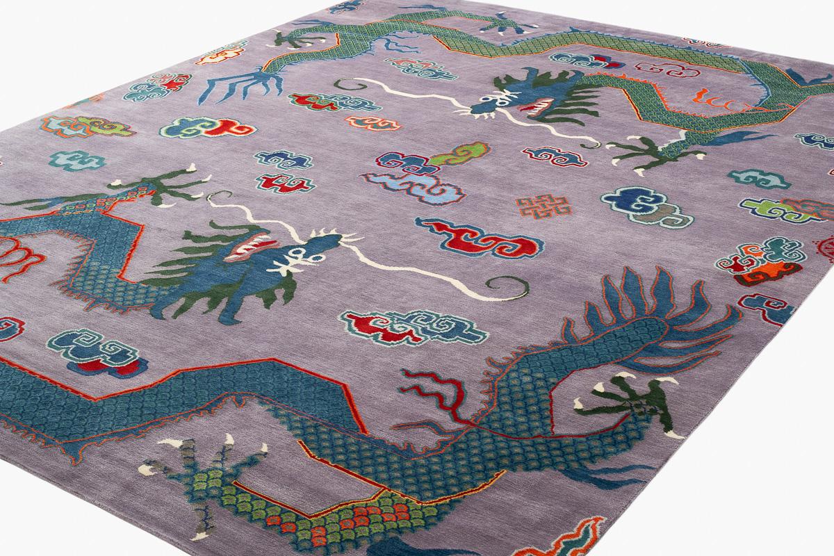 This double dragon design carpet was inspired by Ming dynasty textiles and interpreted into its bold palette by designer Joseph Carini. Woven in luxurious silk and wool in a 150 knot weave, the flowing designs and bright colors stand out against the