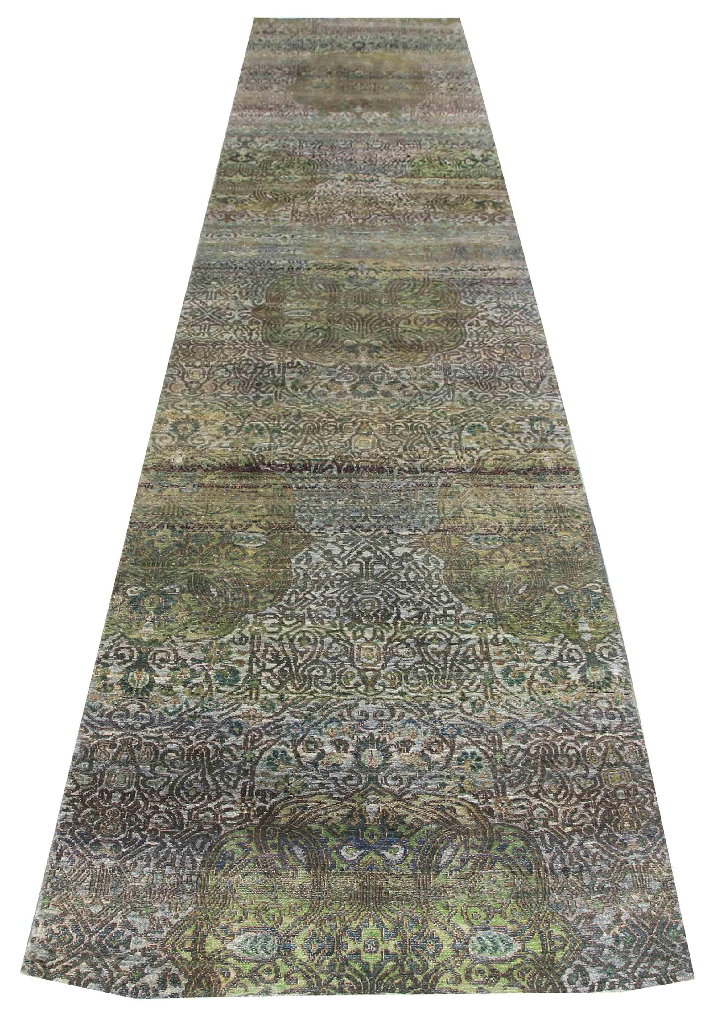 This 3' x 15' silk distressed runner rug is a masterpiece of art that brings together vintage and modern styles. The rug has been transformed by skilled artisans through a series of processes, including washing, sunning, and shearing, resulting in a
