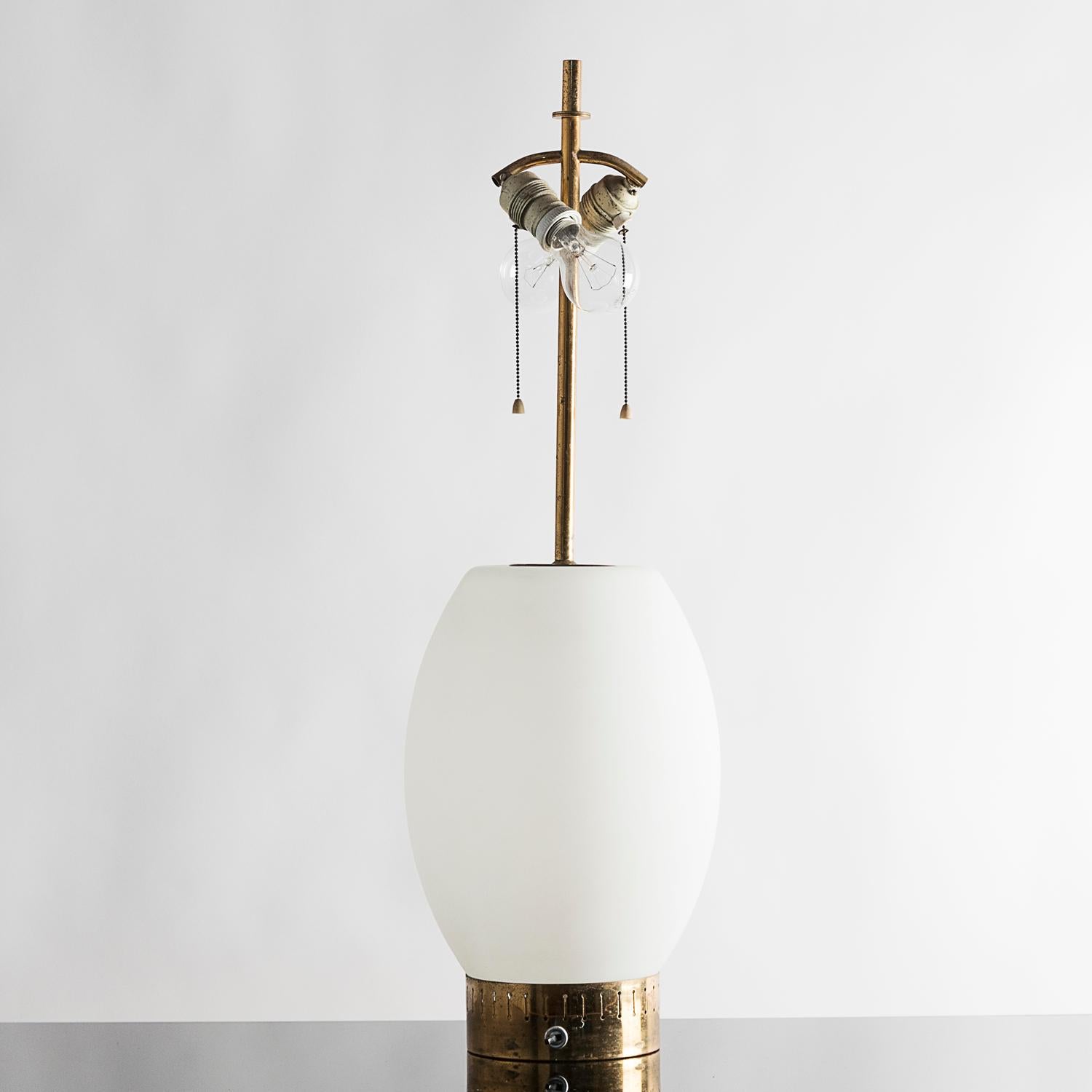 Stilnovo, white opaline glass and brass table lamp with shade from the 1950s. Variant for the model 8055, mid-1950s. Shade in the picture has to be considered a sample for showing the silhouette of the lamp and might be not shipped in case of