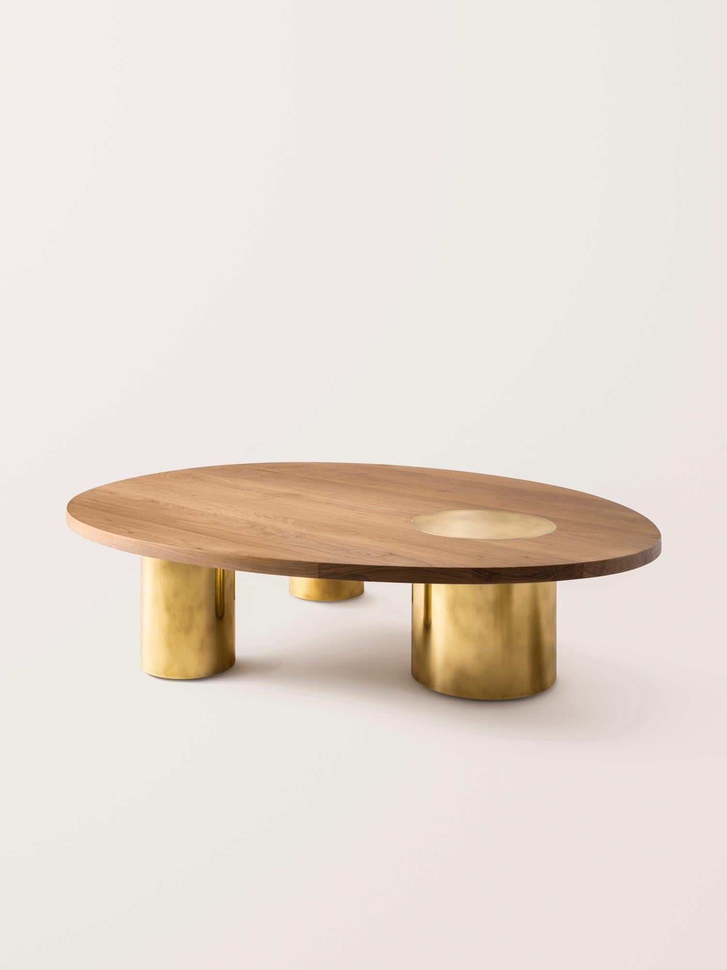 Inspired by the form and function of grain silos, the sculptural Silo Coffee Tables feature solid wood and hand-finished brass or stainless steel wrapped legs. The coffee tables are available in two height options and four sizes to allow for various