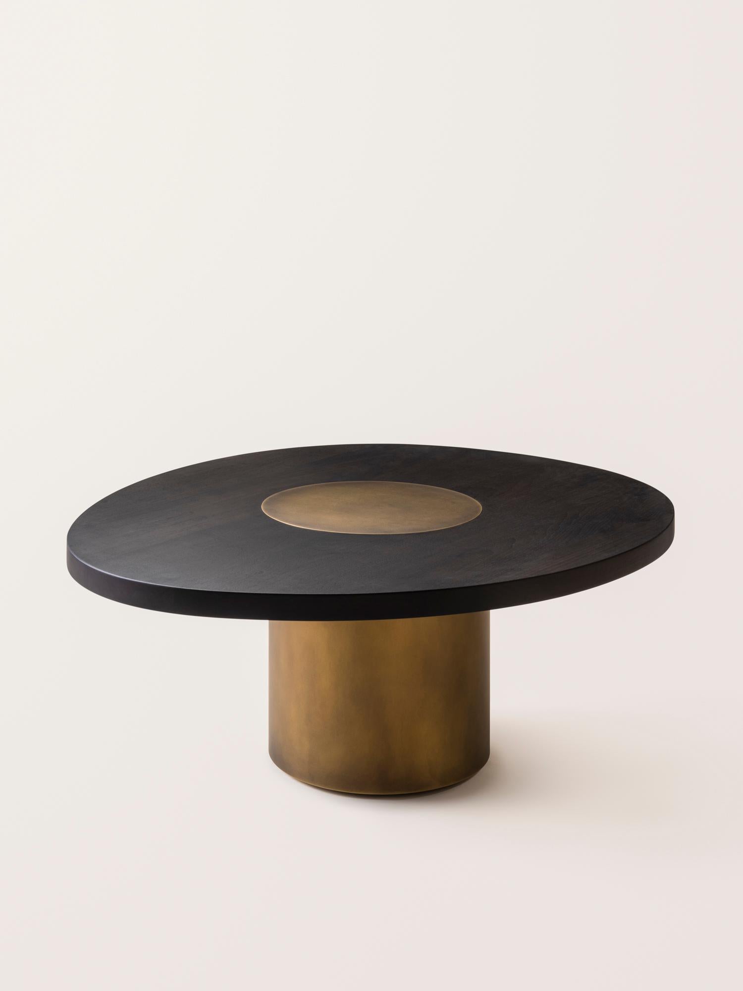 Inspired by the form and function of grain silos, the sculptural Silo Coffee Tables feature solid wood and hand-finished brass or stainless steel wrapped legs. The coffee tables are available in two height options and four sizes to allow for various