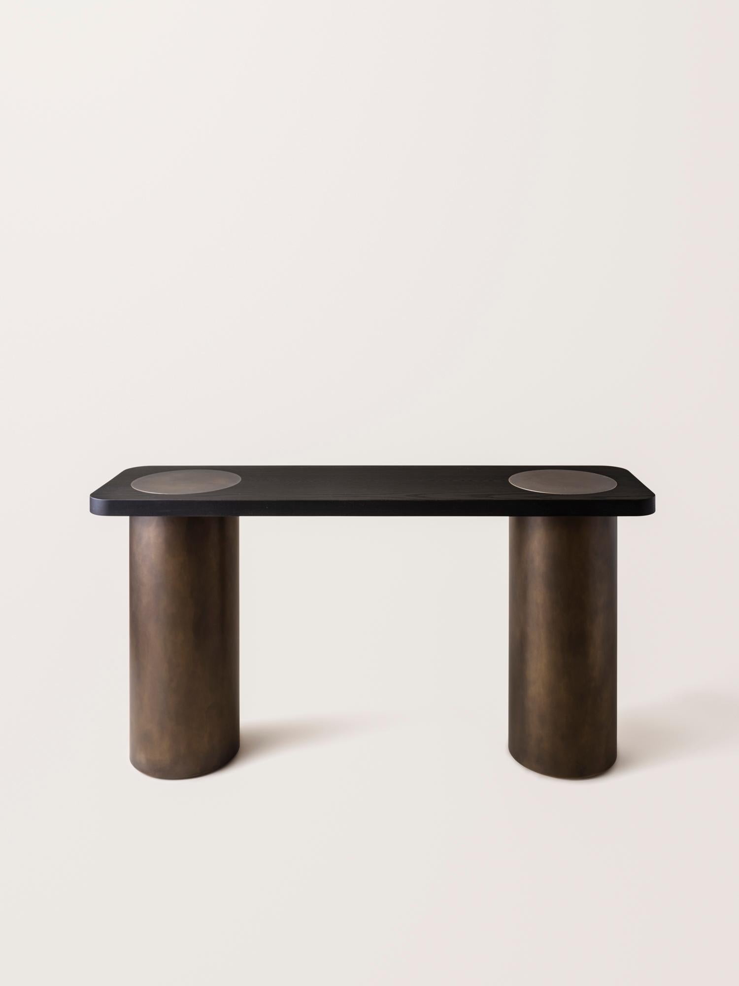 Inspired by the form and function of grain silos, the sculptural Silo Console Table features solid wood and hand-finished brass or stainless steel wrapped legs.

This listing does NOT include the removeable, hollow brass domes shown in last image.