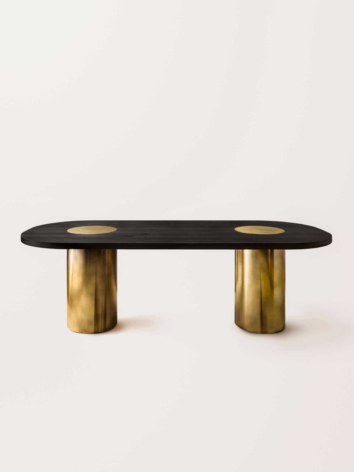 Inspired by the form and function of grain silos, the sculptural Silo Dining Table features solid wood and hand-finished brass or stainless steel wrapped legs.

This listing does NOT include the two brass domes that are pictured in some images, they