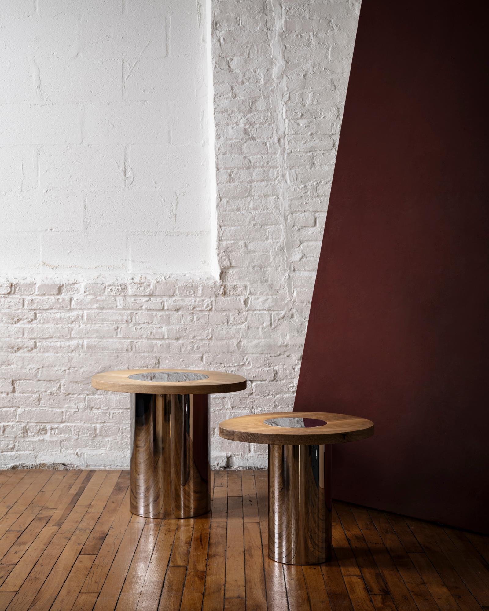 Inspired by the form and function of grain silos, the sculptural Silo Side Tables feature solid wood and hand-finished brass or stainless steel wrapped legs. Available in three sizes and height options to allow for various nesting