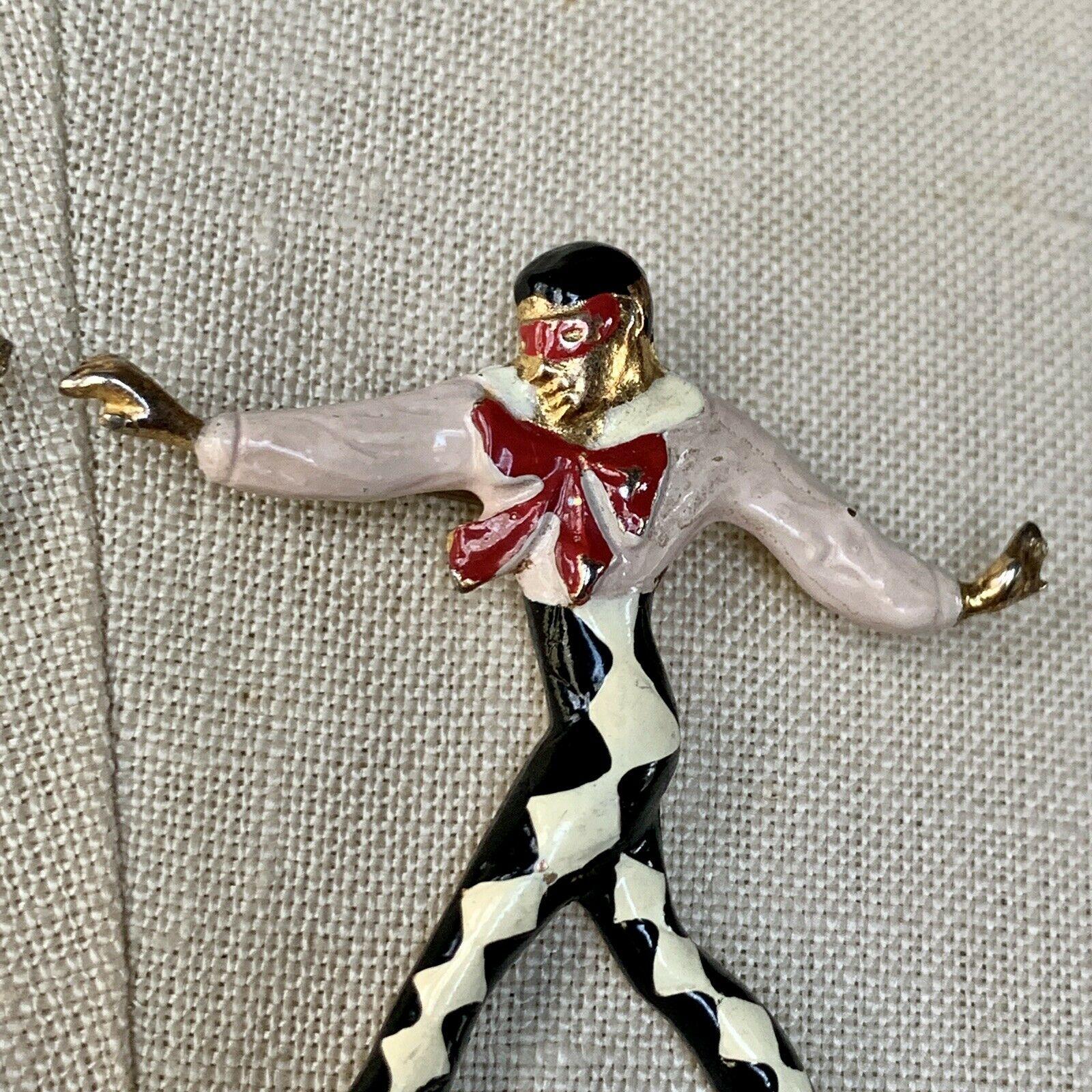 Silson, Pair of Harlequin Columbine Masked Ballet Dancers

Female gold plated base metal with pink, black, and white enamel. Harlequin in a black and white leotard and fancy pink shirt with a big red bow, all in enamel. 

The hallmark 