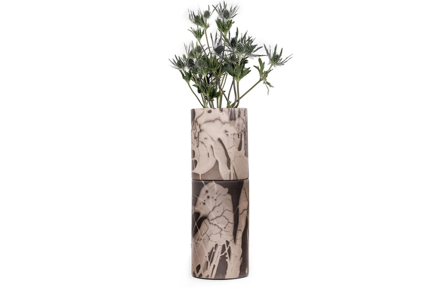Grey Slit Textured casted tall vase By Gilles Caffier

Made from sand and clay and composed mostly of broken grains of quartz, this tall silt vase has a Raku finish. Deep and dark neutral grey with mauve undertones that adds depth to this rippled