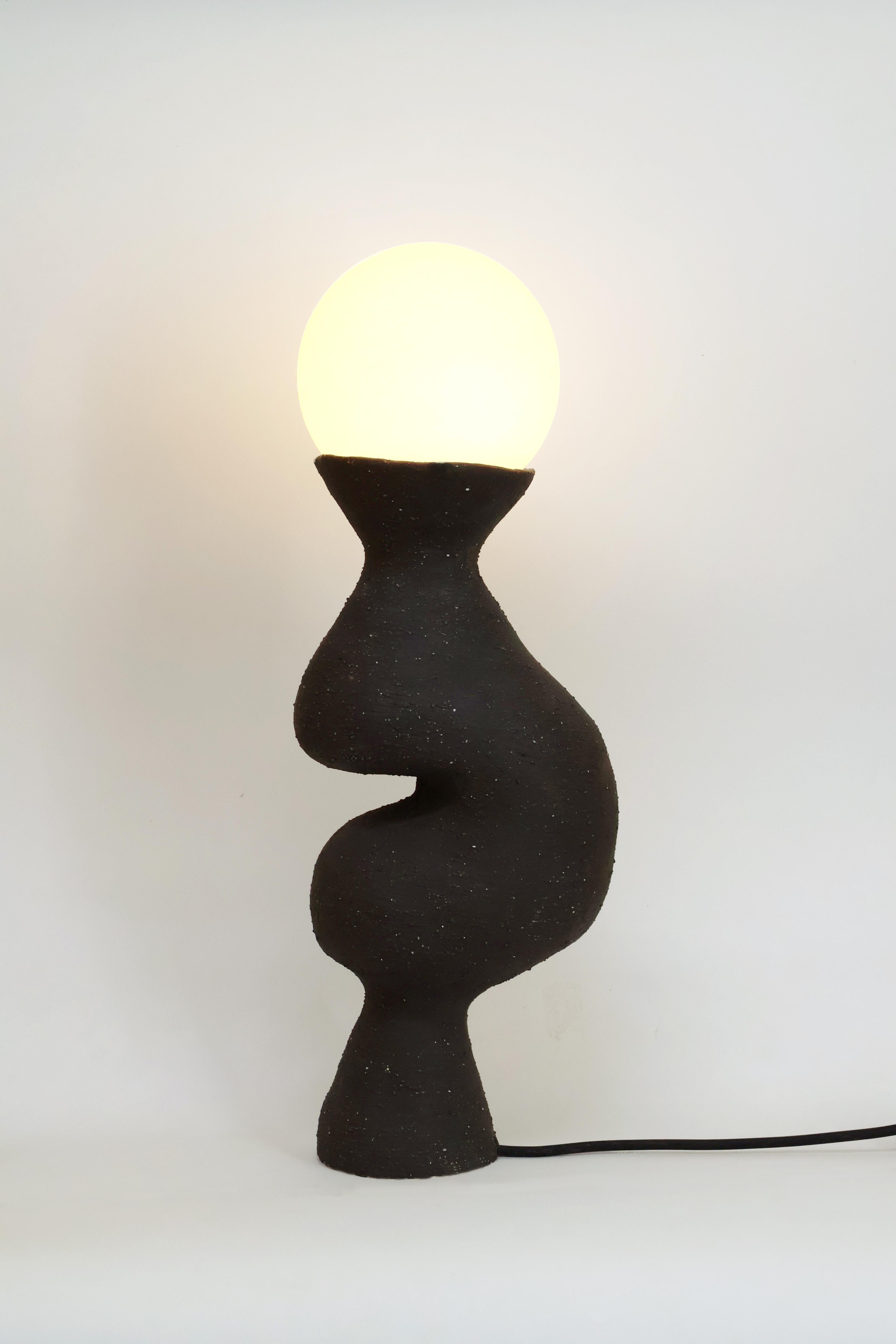 Silueta II Table Lamp by Camila Apaez
Unique
Materials: Ceramic, Glass
Dimensions: W 14 x D 20 x H 53 cm

Ila Ceramica emerged from a process of inner inquiry where ceramics became a space for presence, silence, touch and patience. Camila discovered