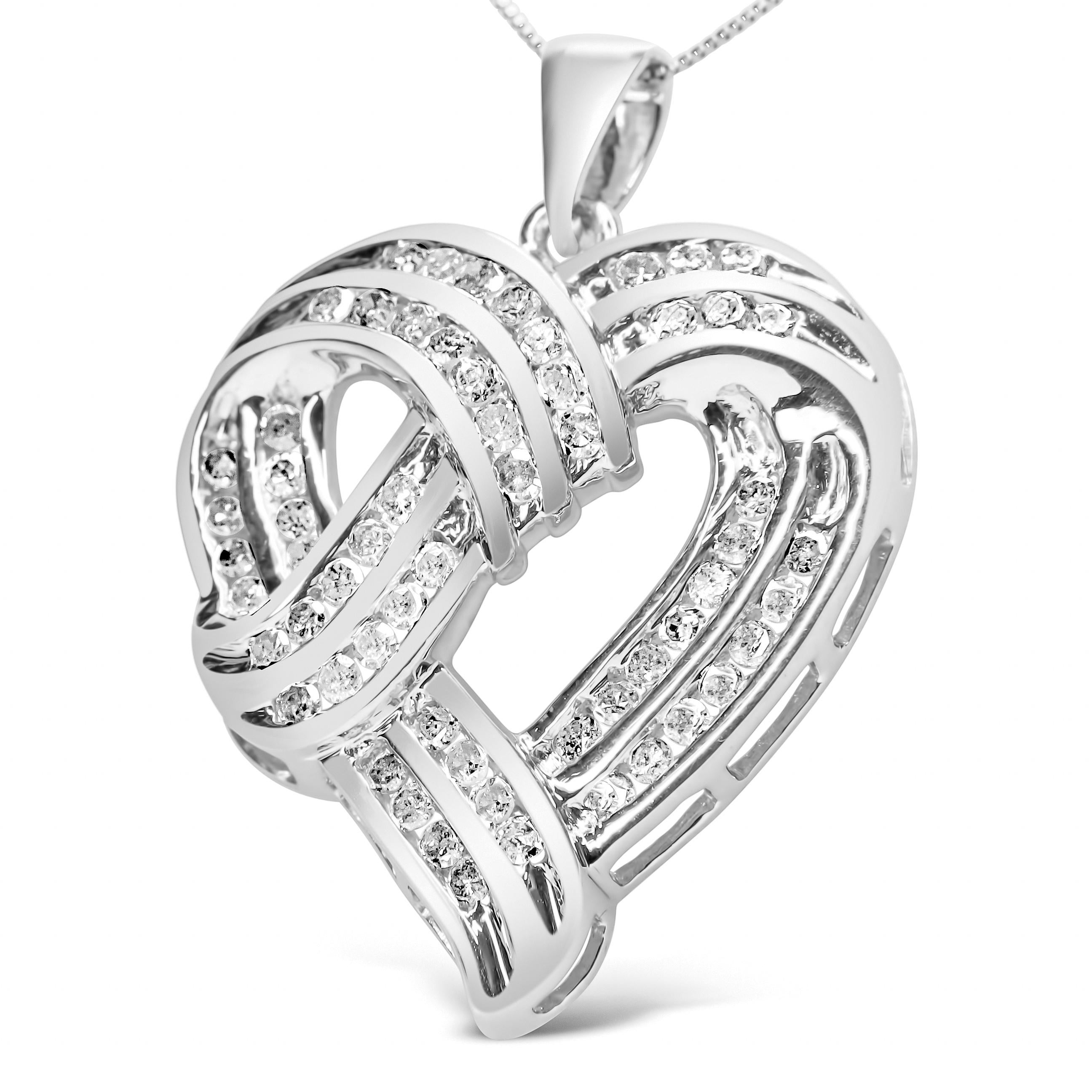 This striking .925 sterling silver pendant necklace features an open heart frame with ribbon-loop detail that is embellished with prong-set round diamonds. The enchanting sparkle is captured from sixty diamonds of a total 1 1/4 cttw and an