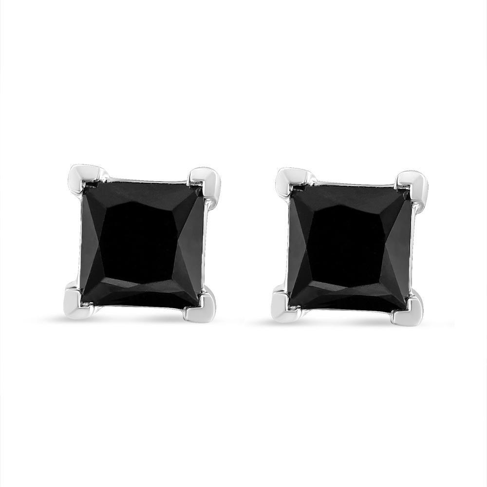 Elegant and timeless, these gorgeous .925 sterling silver solitaire stud earrings feature bold and beautiful heat treated, color enhanced black diamonds in a four prong setting. The earrings feature screwback closures. The notched posts and friction