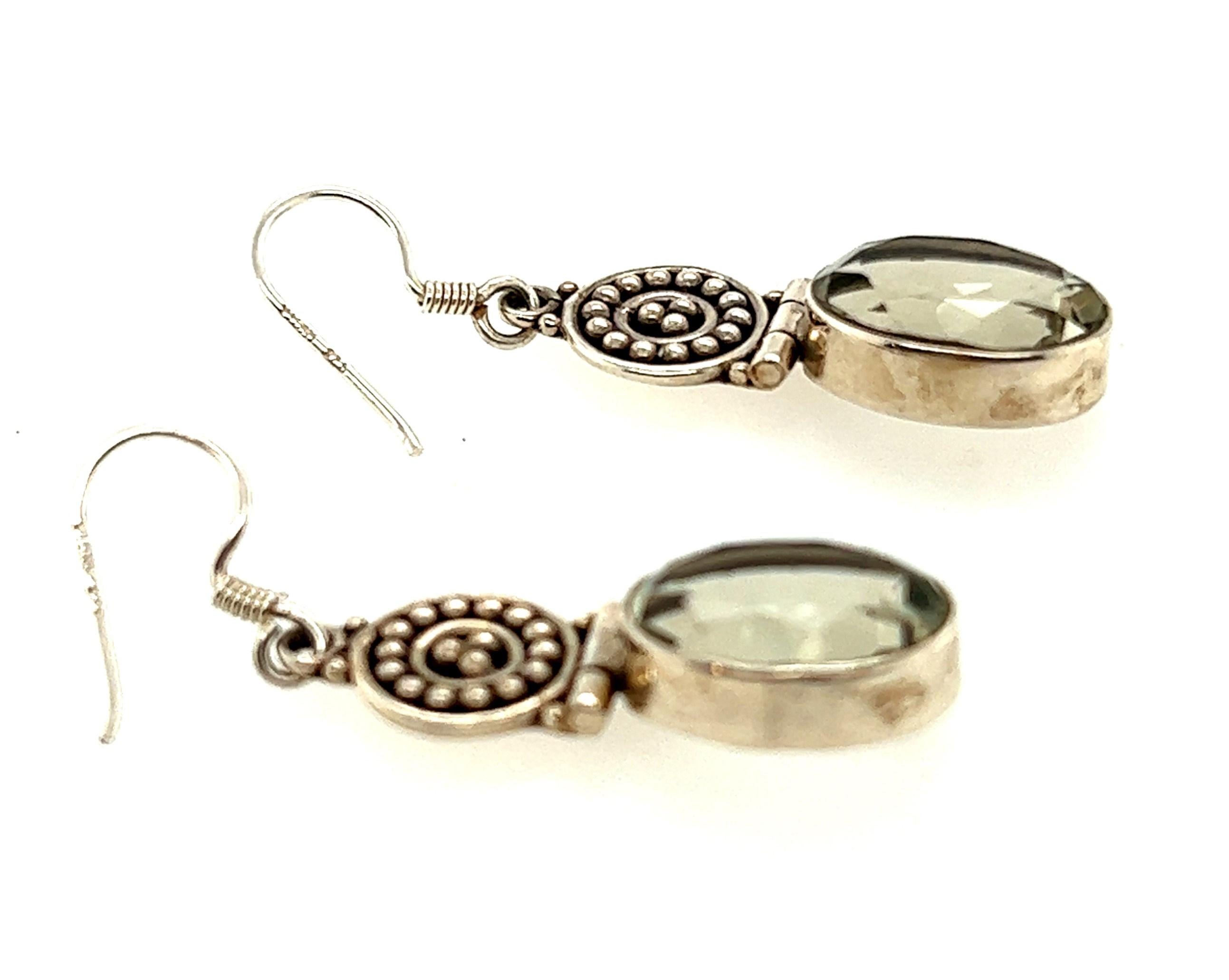 If you want to make a statement, these earrings will do the trick!

These earrings have a granulated disk at the top with a bezel set drop suspended from them at the bottom of the earrings. The drops contain oval cut prasiolites weighing