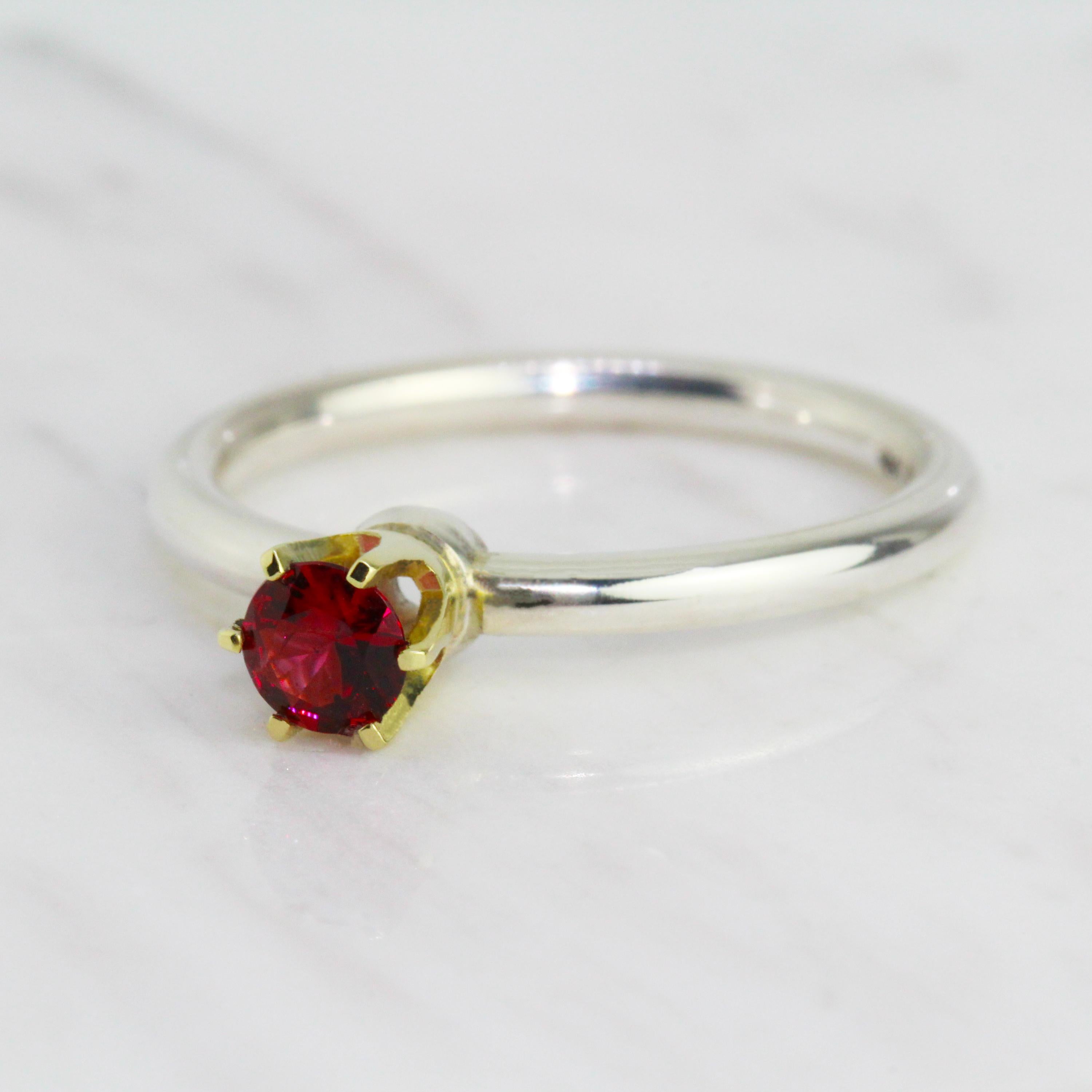 Sitting high and proud a vibrant red spinel. A vibrant red spinel takes centre stage in this unique Friederike Grace design. The delicious red spinel is held in an elegant 14k yellow gold six-prong setting on top of a comfortable round profile ring
