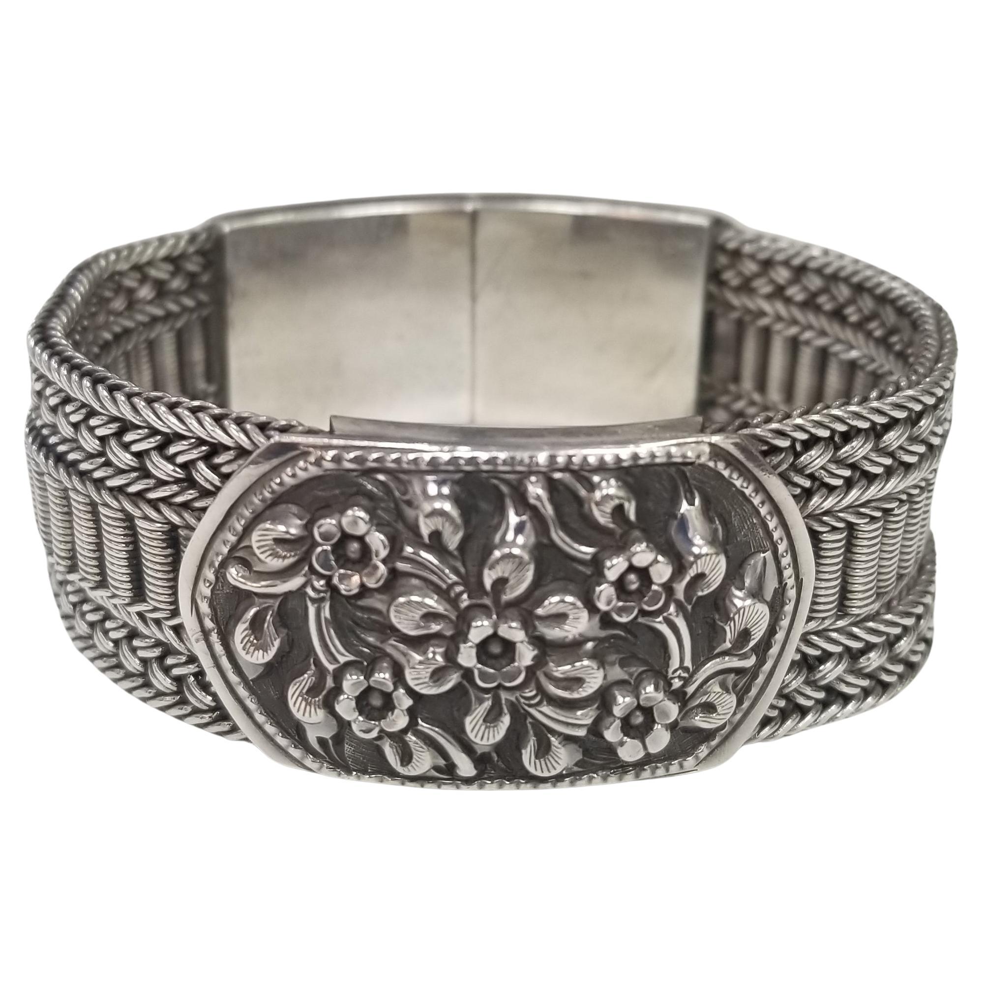 Silver 3 row mesh bracelet with flower motif center and on clasp